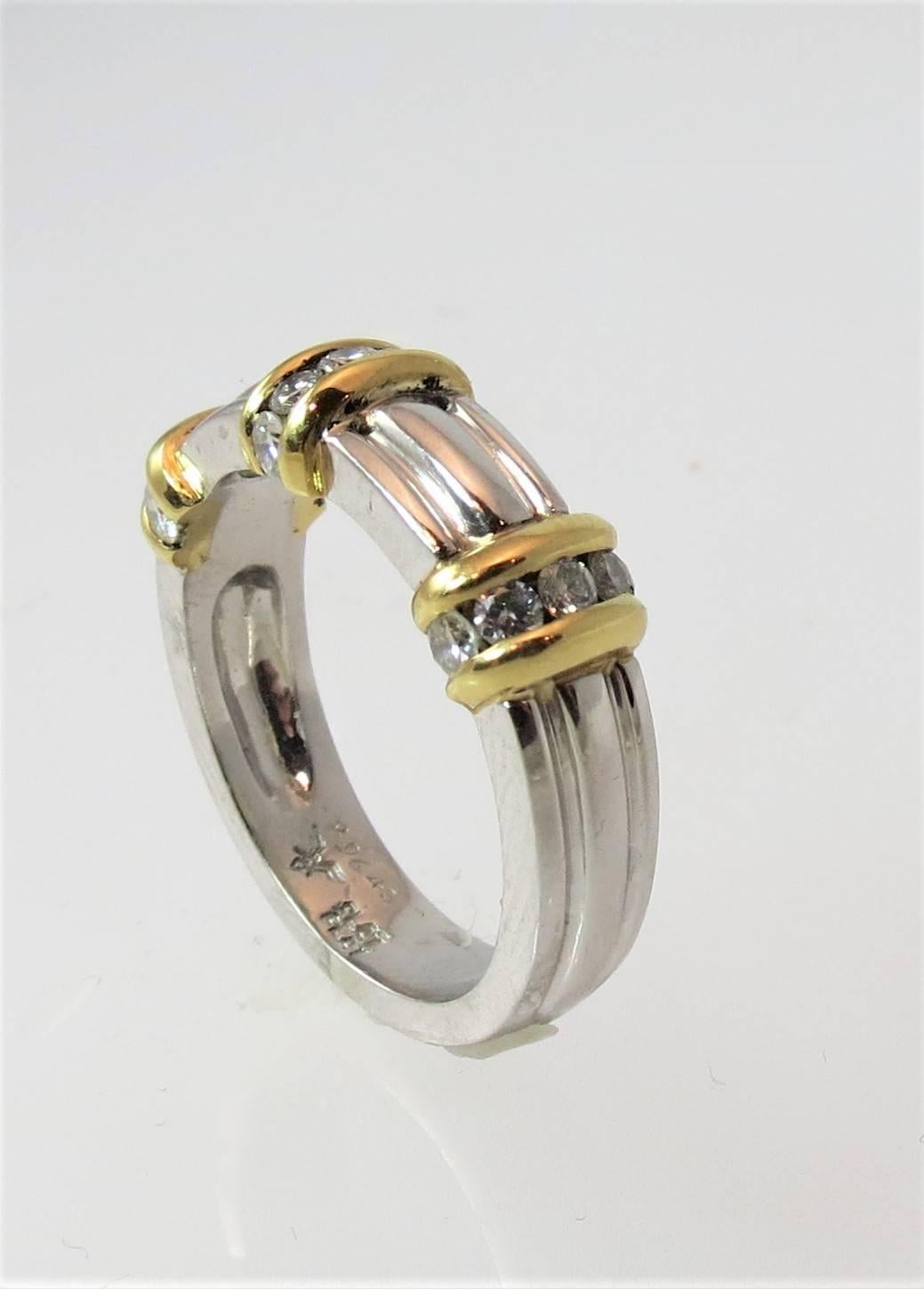 Gents Platinum and 18K yellow gold diamond band ring set with 15 full cut round diamonds weighing 68cts
Finger size 9.5, may be sized