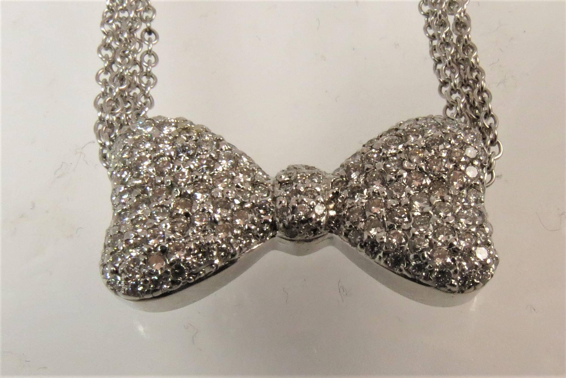 Stunning 14K white gold bow design, pave diamond necklace, weighing 1.80cts total, with five chains.
Length 15.5 inches