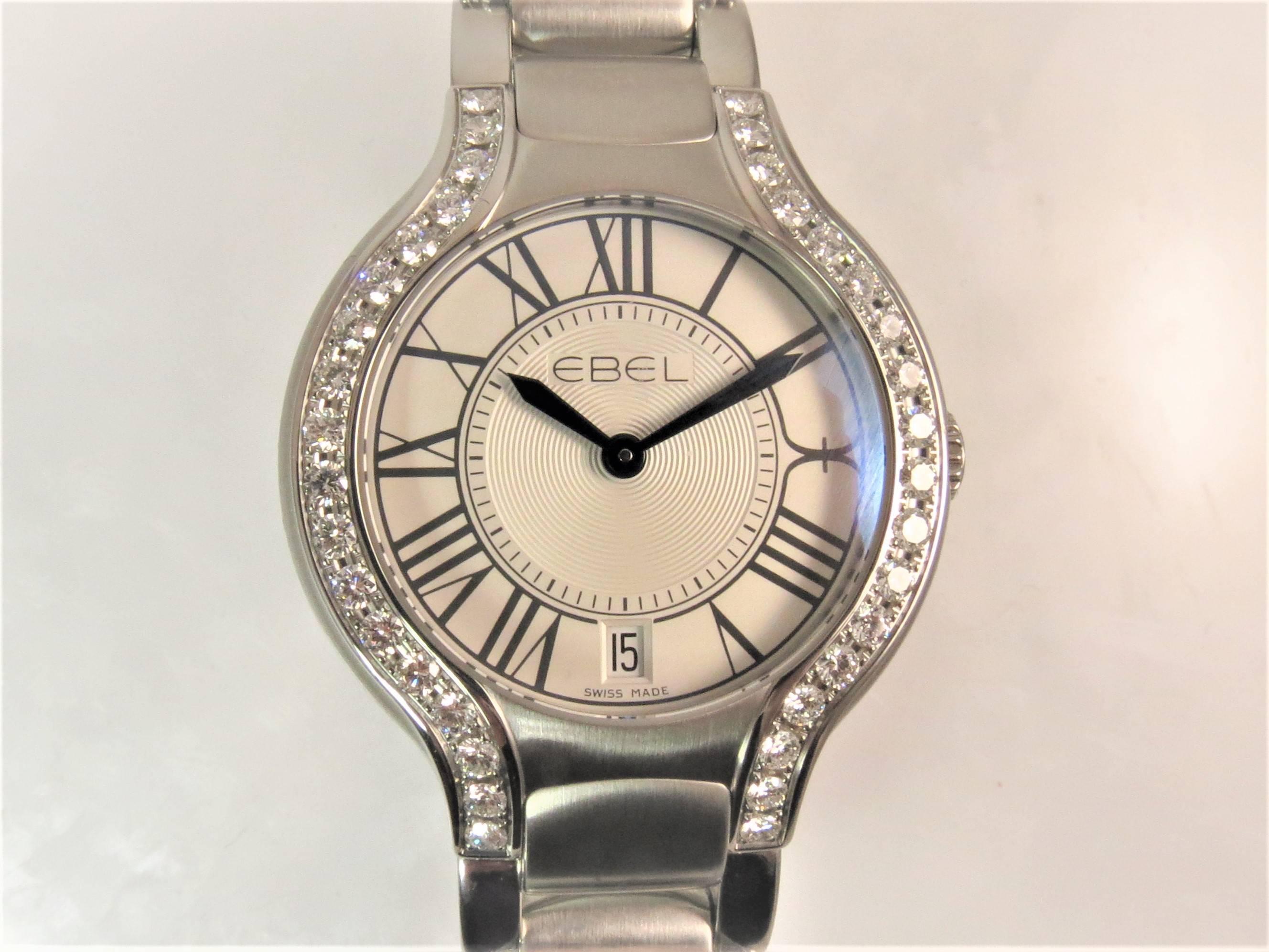 Brand new, never worn, Lady's Ebel Beluga Grande Steel Diamond Bracelet Watch, quartz movement, silver dial, blue hands, date window, deployant clasp, 36 full cut round diamonds on case weighing about 1.69cts.
Model Number 1216071
Serial Number