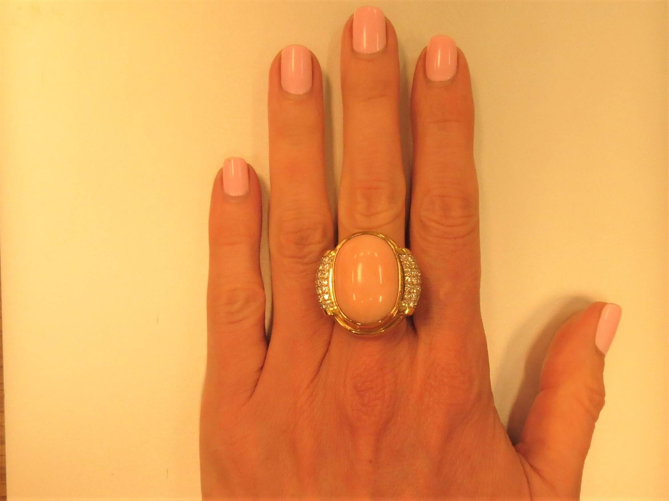 Impressive 18K yellow gold cabochon angle skin coral and diamond ring by Susan Berman, set with 33.50ct cabochon angle skin coral and 70 full cut round diamonds weighing 1.43cts, G-H color, VS clarity. 
Finger size 5, may be sized