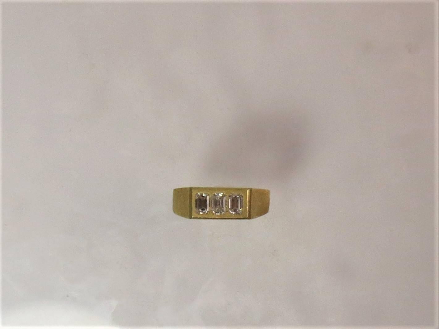 18K yellow gold gents band ring set with three emerald cut diamonds weighing .90cts, G color, VS clarity

finger size 8.5, may be sized
