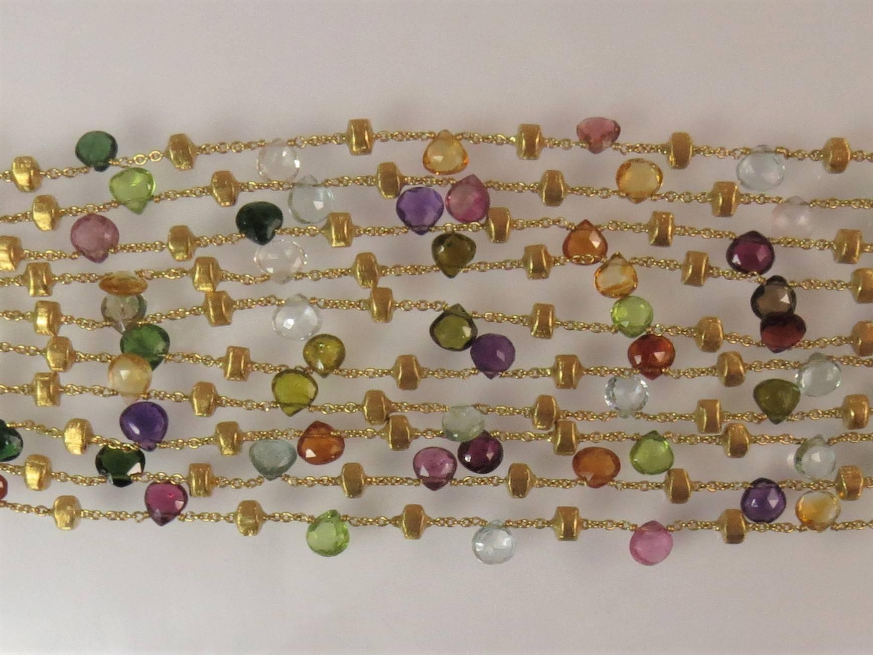Marco Bicego 18K yellow gold multi strand bracelet, with amethyst, garnet and blue topaz, and 18K yellow gold nuggets,  7 inches long, 1.5 inches wide. 