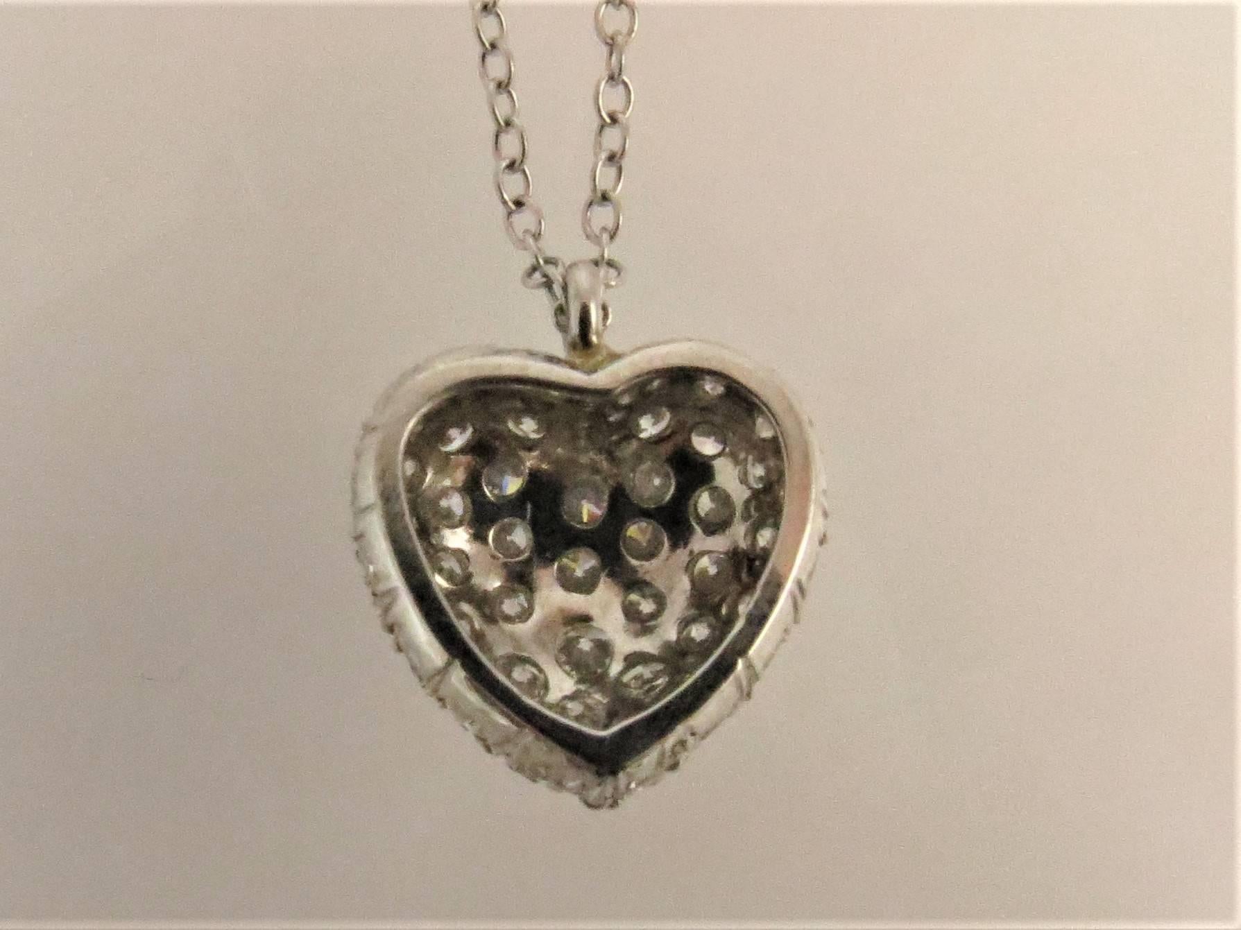 18K white gold diamond heart pendant  pave set with 41 full cut round diamonds weighing 1.80cts, G-H color, VS-SI1 clarity, suspended from 16 inch white gold chain.
