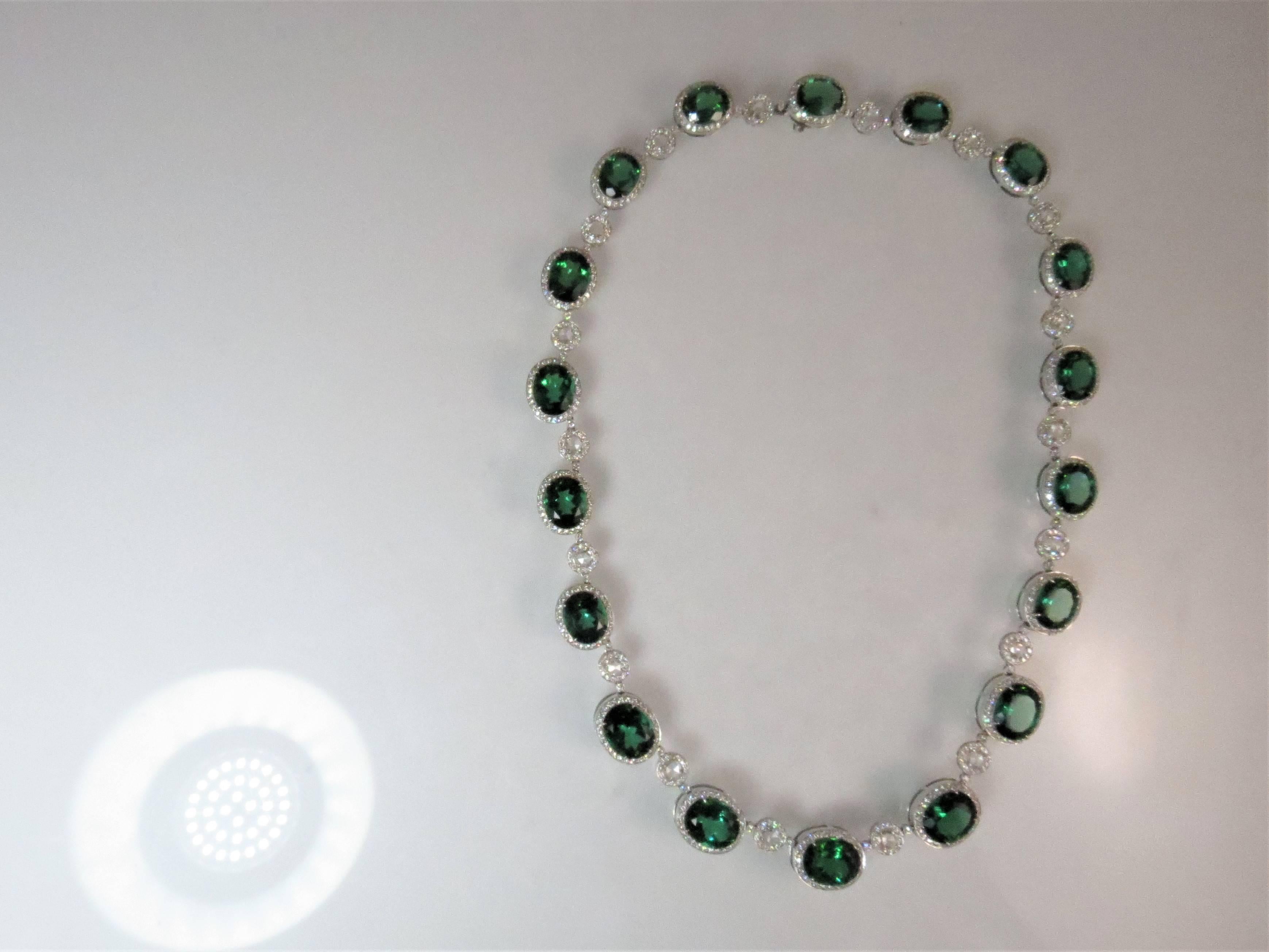 Gorgeous 18K white gold necklace with18 oval faceted green tourmalines weighing 70.29cts and 18 rose cut diamonds weighing 2.63cts and round diamonds weighing 6.60cts.
Necklace length is 16 inches.