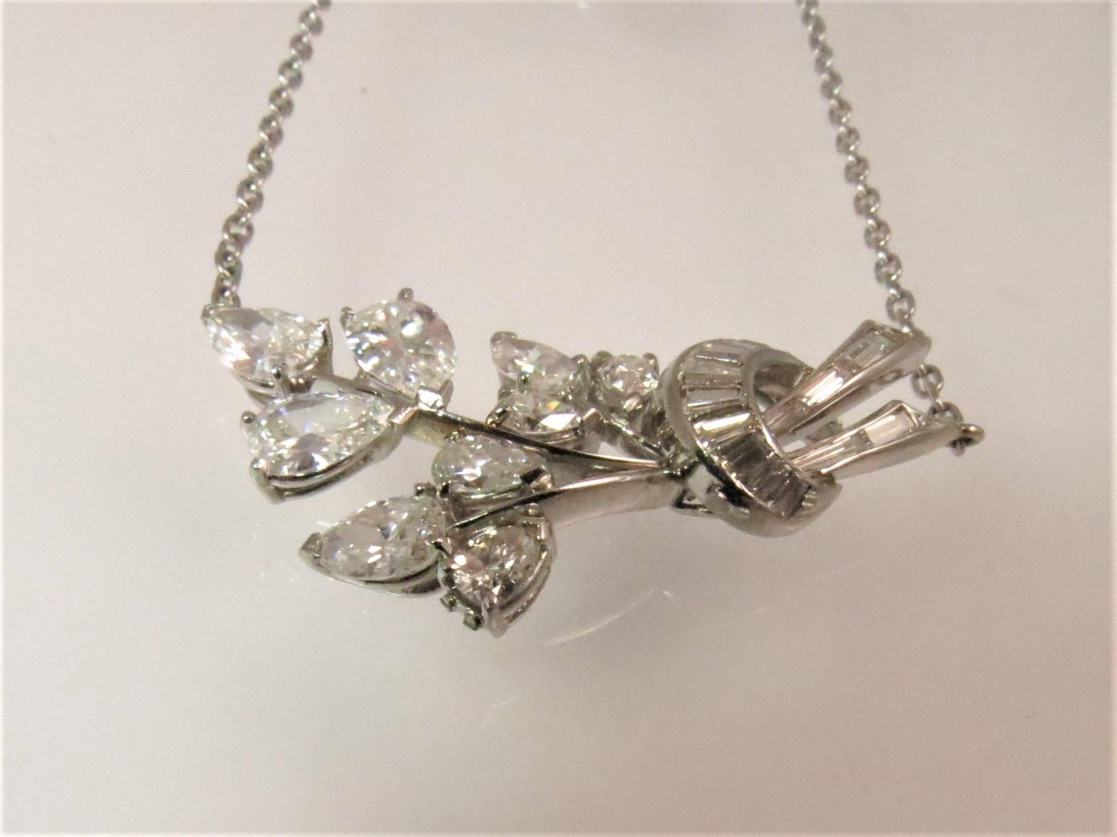 Platinum necklace with floral design consisting of 9 pear shape diamonds weighing 2.25cts and 15 baguette diamonds weighing .60cts, G-H color, VS clarity 