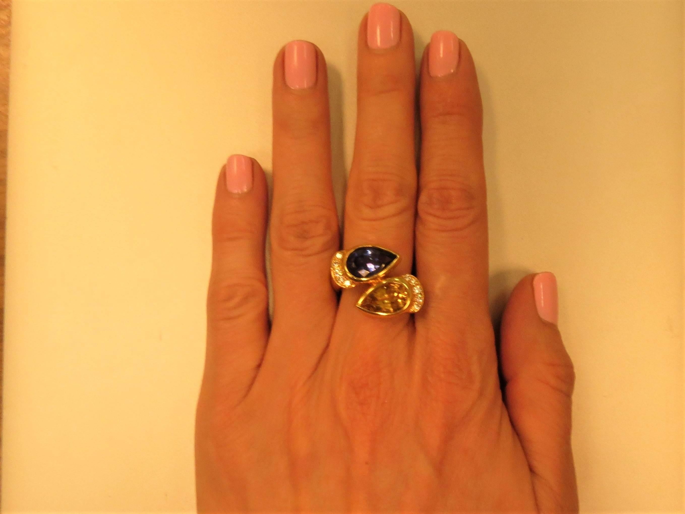 Susan Berman 18K yellow gold ring, set with 2 pear shape stones, one Tanzanite and one Beryl  and 24 full cut round diamonds weighing .82cts, G-H color, VS clarity. 
Finger size 5.75. May be sized