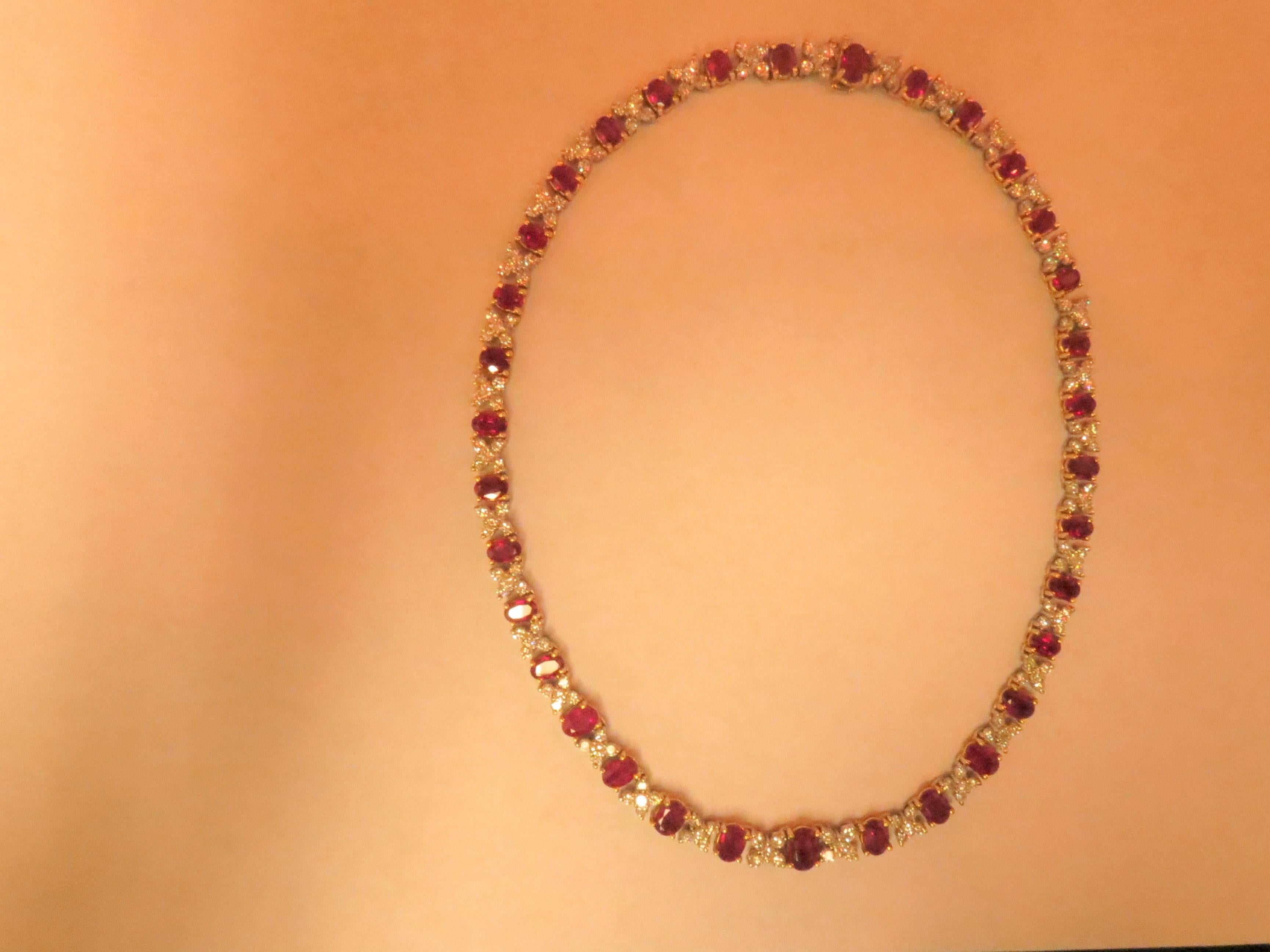 18K yellow and  white gold necklace set with 34 oval rubies weighing 20.96cts and 170 full cut round diamonds weighing 8.92ct, G-H color, VS clarity. Necklace tapers from 3/16 to 1/4 of an inch.