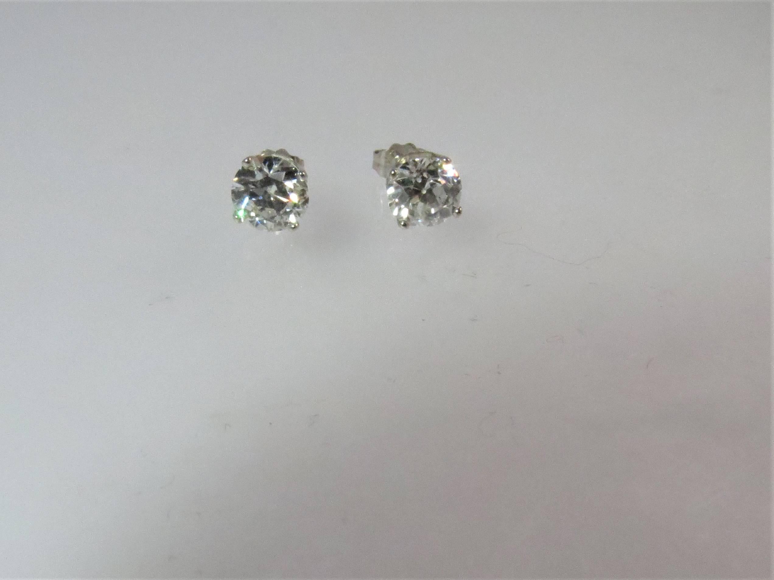European cut diamond stud earrings, weighing 2.23cts total, GIA certified, I color, SI2 and H color, SI2 set in four prong platinum mountings,