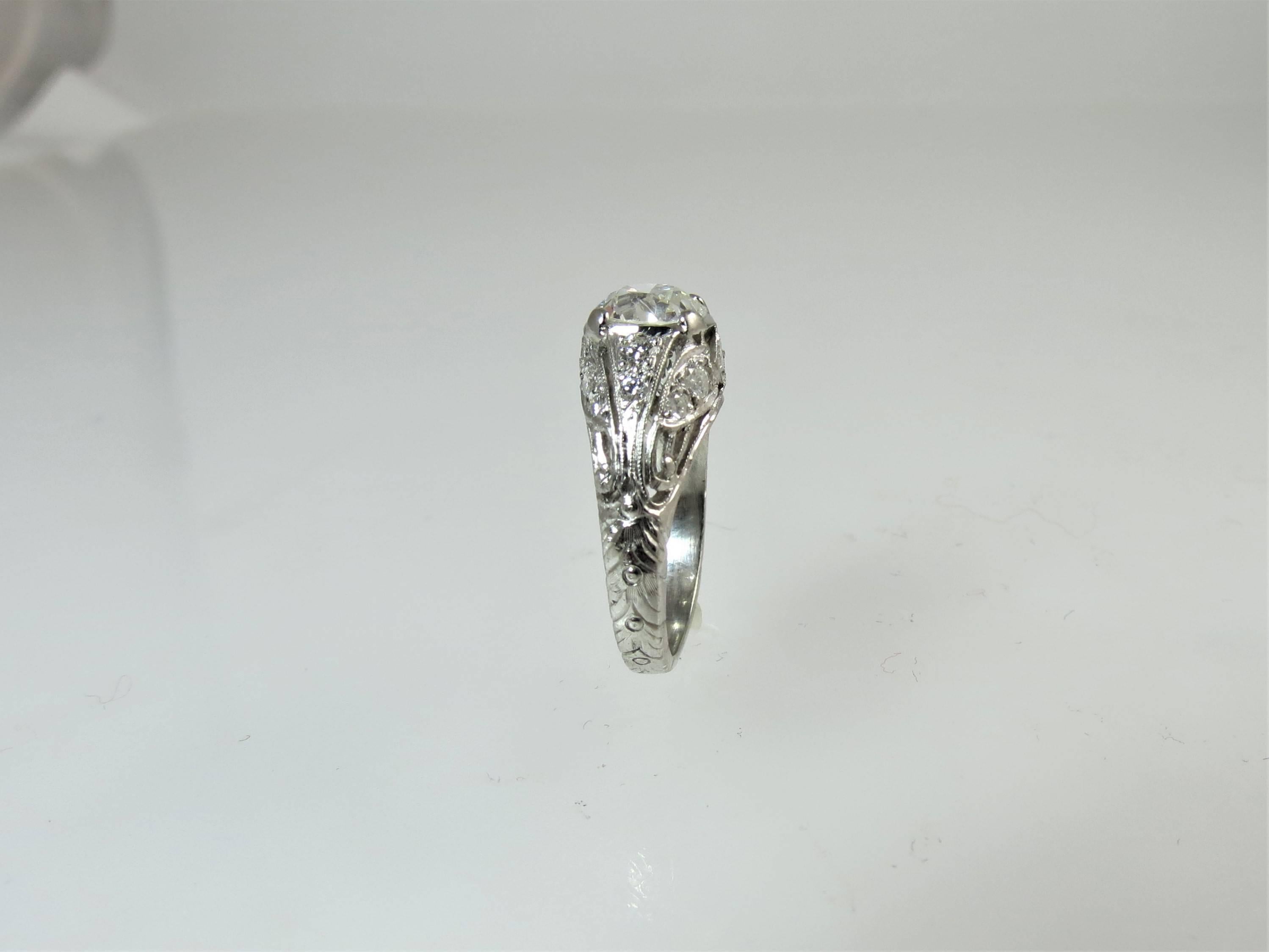 Vintage Platinum Ring, prong set with one European cut diamond, weighing 1.25cts, GIA certified (lab report #1182914479) F color, SI2 clarity and 14 bead set,  full cut round diamonds weighing .47cts, F color, VS clarity 
Finger size 5, may be sized