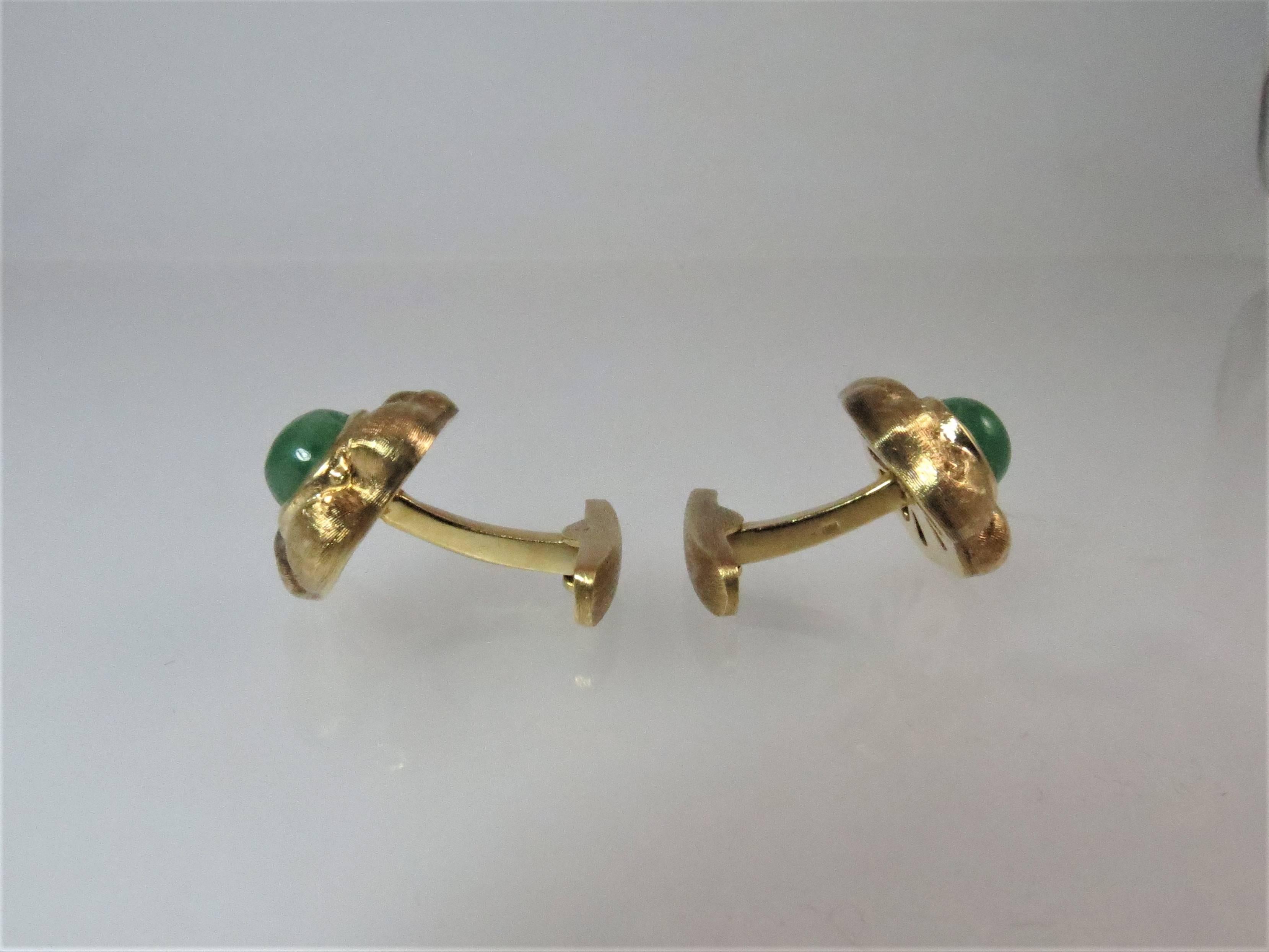18K yellow gold cufflinks, florentine finish,  bezel set with two cabochon emeralds measuring 9mm x 8mm