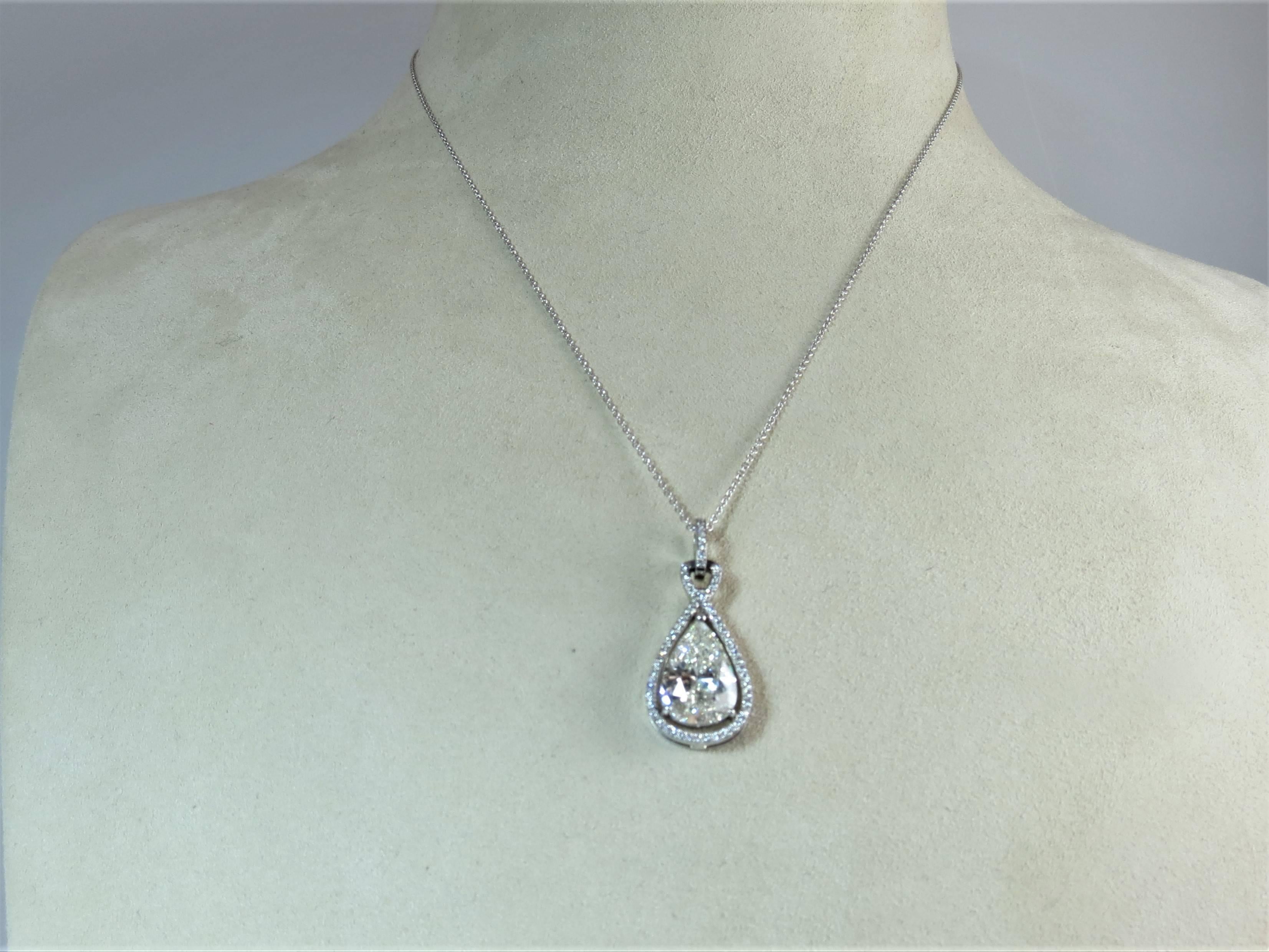 Bez Ambar platinum diamond pendant mounting with 61 full cut round diamonds weighing .21cts, set in center with 3.07 pear shape diamond, GIA certified, J color, VS2 clarity, suspended from 18 inch white gold chain.
Pear shape diamond may be sold