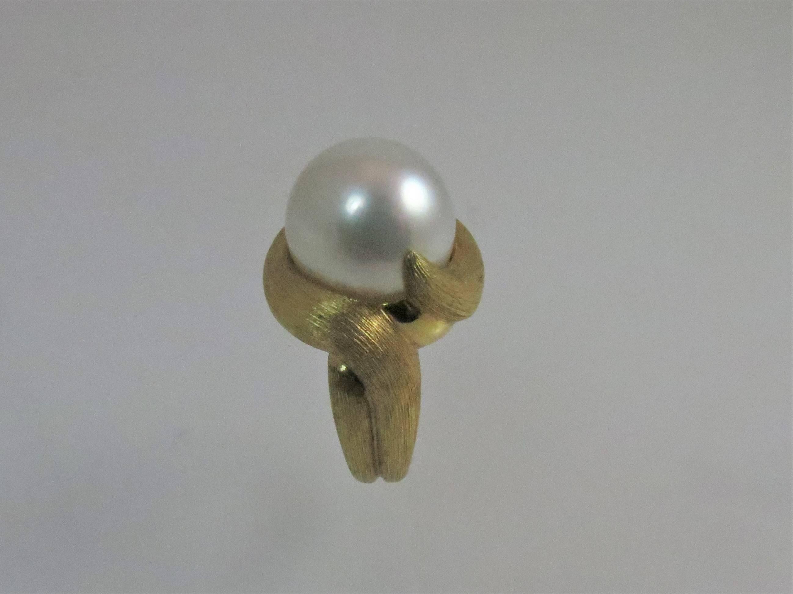 Henry Dunay 18K yellow gold ring, Sabi finish, set in center with one South Sea Pearl, 14mm.
Finger size 6, may be sized