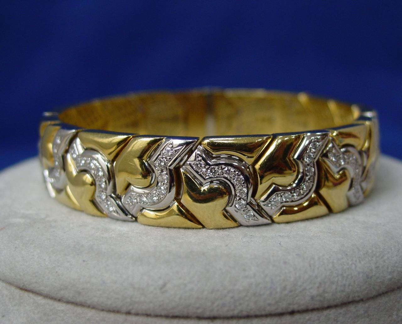 An 18 Karat Yellow and White Gold Diamond Bracelet. This flexible link bracelet features an abstract design of round brilliant diamonds set in 18 karat white gold with an approximate weight of 1.90 carats. 7 1/2
