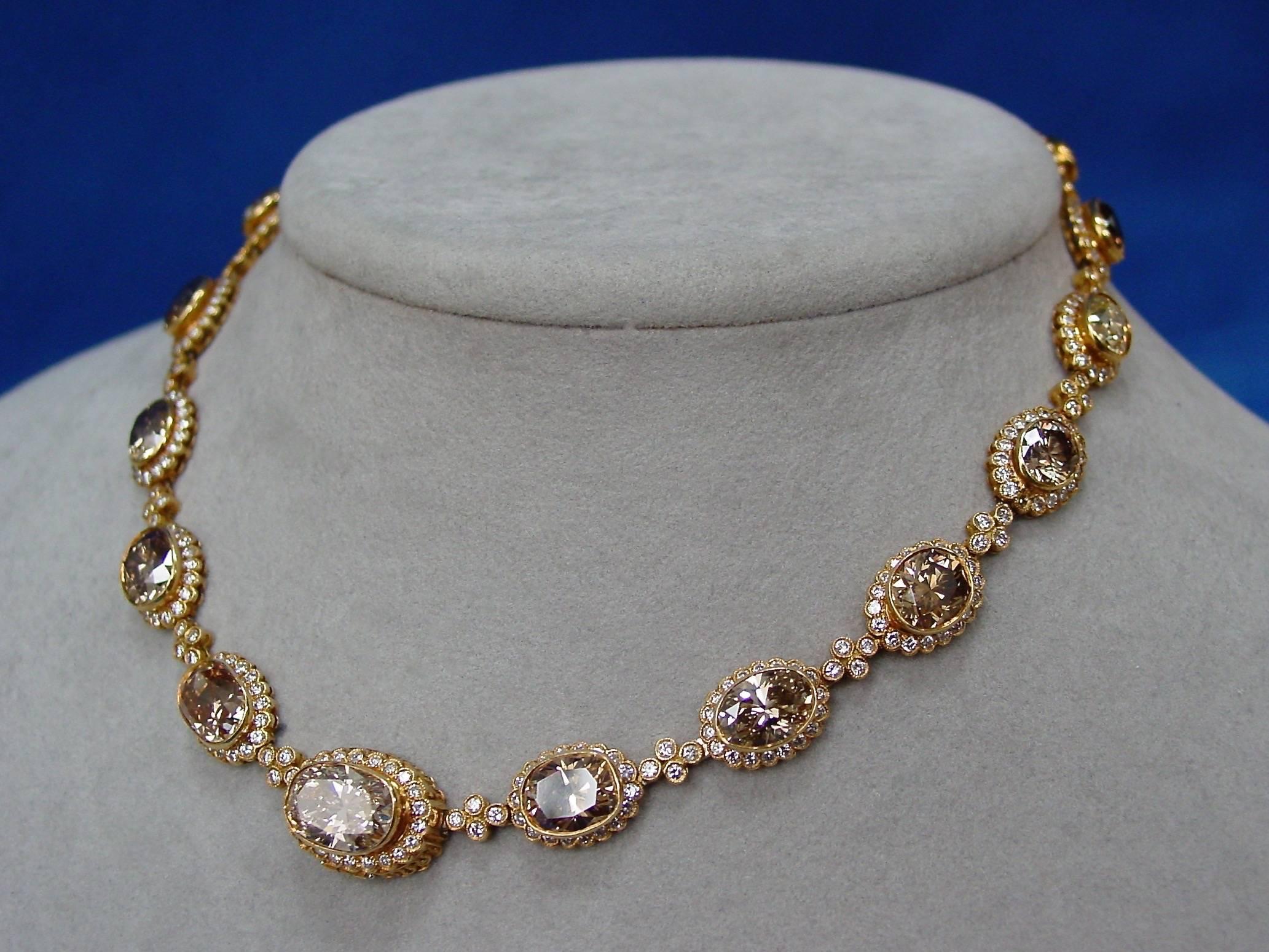 A Fancy Colored Diamond Necklace Mounted in 18 Karat Yellow Gold by Julius Cohen. This beautifully fabricated necklace features oval bezel set diamonds in a range of light yellow to deep brown, set off by flutings of round brilliant diamonds and