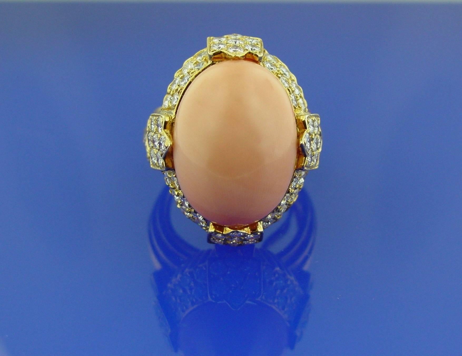 This gorgeous ring features a lovely pink coral cabochon of approximately twenty-two carats highlighted by round brilliant diamonds in an 18 karat yellow gold mounting. With French hallmark and maker's mark.
Diamonds-approximately 3.40 carats in