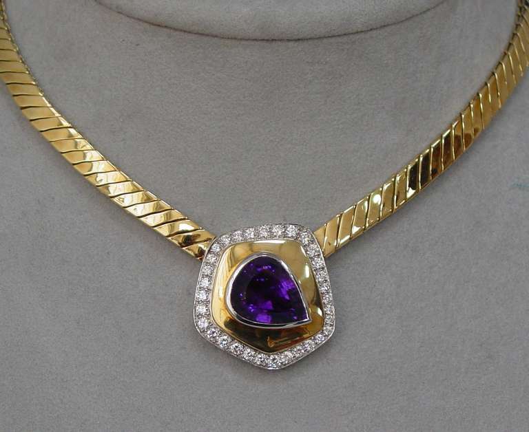 An 18 karat yellow gold, platinum, amethyst and diamond 16 "necklace by Paloma Picasso for Tiffany & Co.. The necklace is set with an off set pear shaped amethyst, weighing approximately 10.50 carats and round brilliant cut diamonds