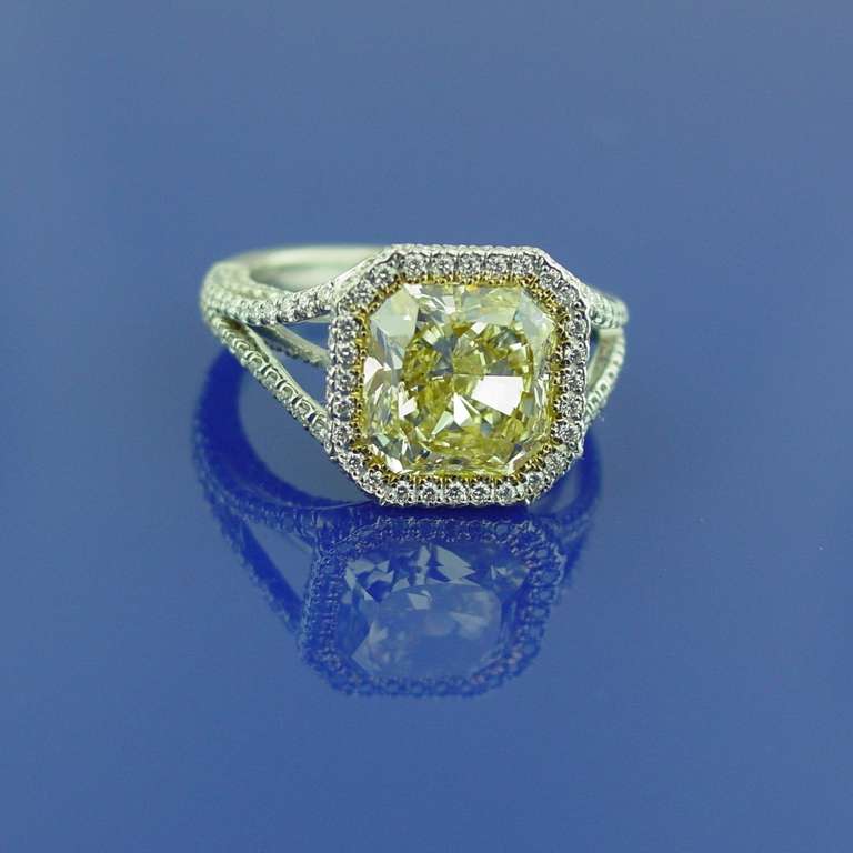 A fancy yellow diamond and platinum ring featuring a 4.58 radiant cut  fancy yellow diamond in a 1.14 carat white and yellow diamond pave mounting set in platinum and 18 karat yellow gold.

With GIA Certificate # 17549527 stating Fancy Yellow, 