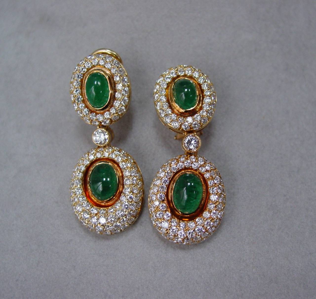 A Cabochon Emerald and Diamond Necklace, Earring and Ring Suite Mounted in 18 Karat Yellow Gold. Featuring approximately 18.80 carats of round brilliant diamonds, G-H in color, VS in clarity and approximately 21 carats of well matched bright,