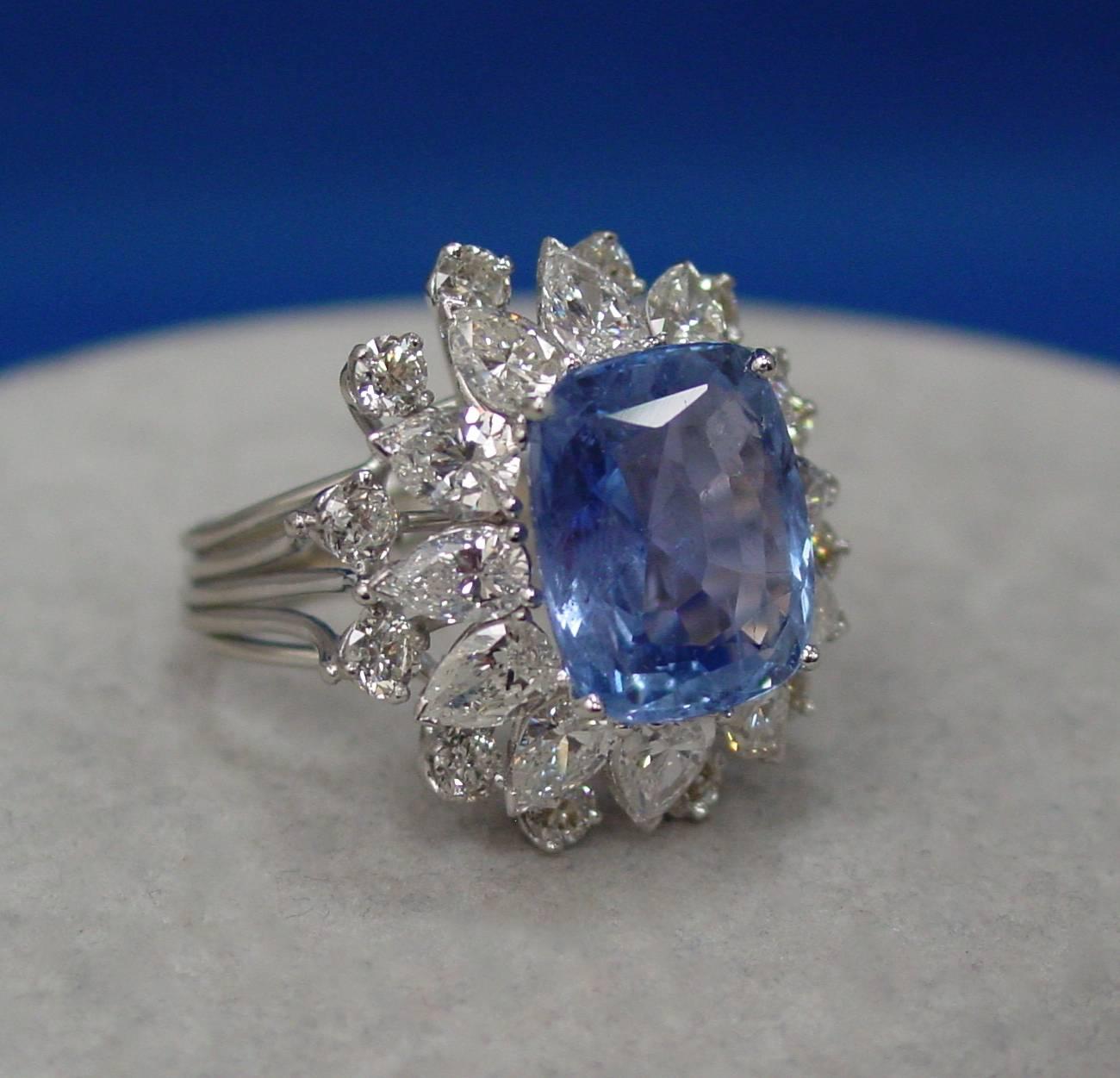 Ceylon sapphire and diamond ring featuring an exquisite antique cushion shaped sapphire weighing 11.06 carats. The sapphire is complemented by pear and round shaped diamonds weighing approximately 6.75 carats in a modern platinum setting. With AGL