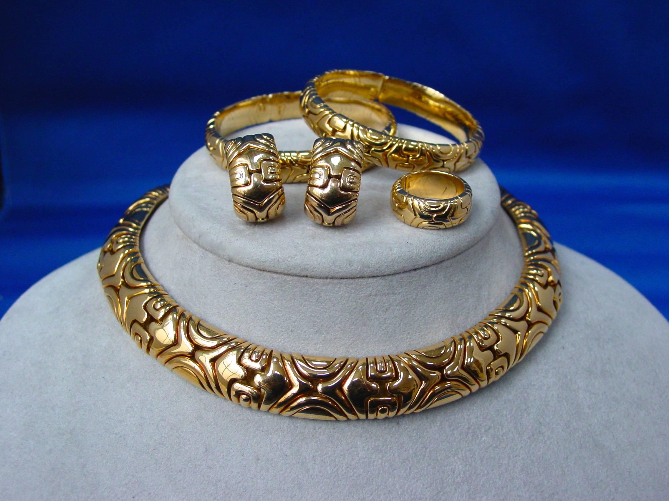 An 18 Karat Yellow Gold Suite of  “Alveare” jewelry by Bulgari. This incredibly collectible suite consists of two bracelets, a ring, a pair of clip earrings and a 15” necklace. We've come across individual pieces before but a complete suite is a
