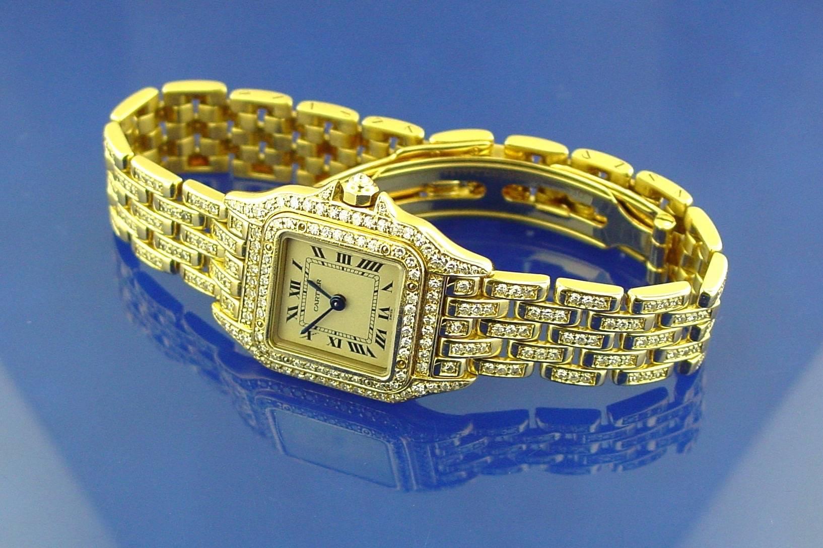 An 18 Karat Yellow Gold and Diamond Cartier Ladies Panthère Watch. This classic watch is sized for a 6.5