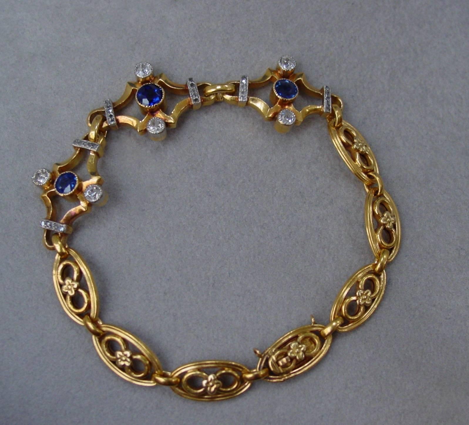 A very pretty 18 karat yellow gold sapphire and diamond bracelet from the early 20th century. With French hallmarks and stamped 18k this bracelet has a lovely soft patina and is set with approximately .60 carats of sapphires and accented by