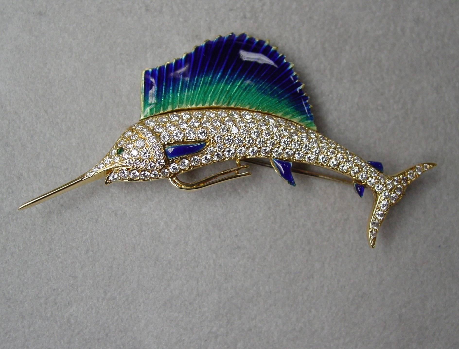 An 18 karat yellow gold diamond and enamel sailfish brooch. This wonderful sailfish features a diamond pavé body weighing approximately two carats,  beautifully enameled fins and an emerald eye. With plaque on reverse engraved "Shammy 5/92