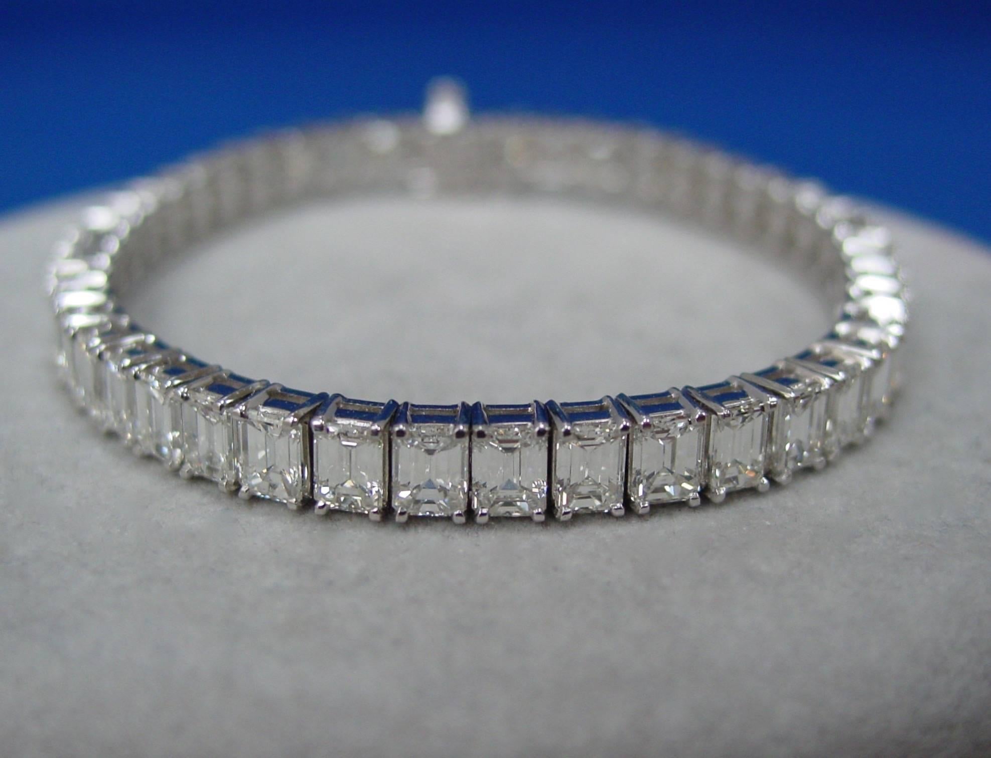 An Emerald Cut Diamond Line Bracelet Mounted in Platinum. This beautifully made classic bracelet is set with forty -seven well matched diamonds G-H in color, VS in clarity, weighing approximately 17.85 carats in total. 