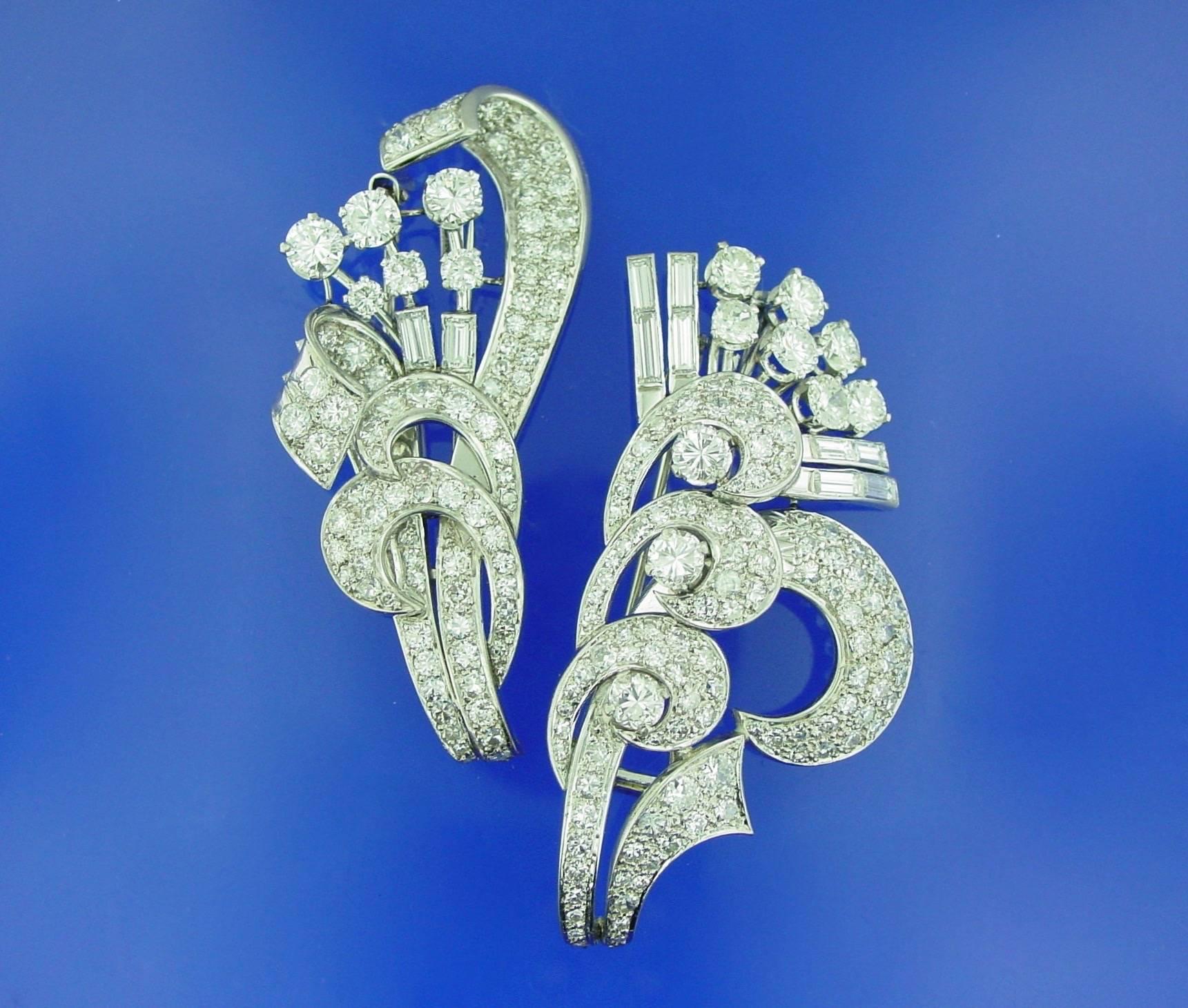 A lovely and versatile diamond brooch mounted in platinum. The pair of curvilinear brooches are joined together by a detachable frame and are equally beautiful when worn separately. Each brooch is set with round and baguette shaped diamonds with a