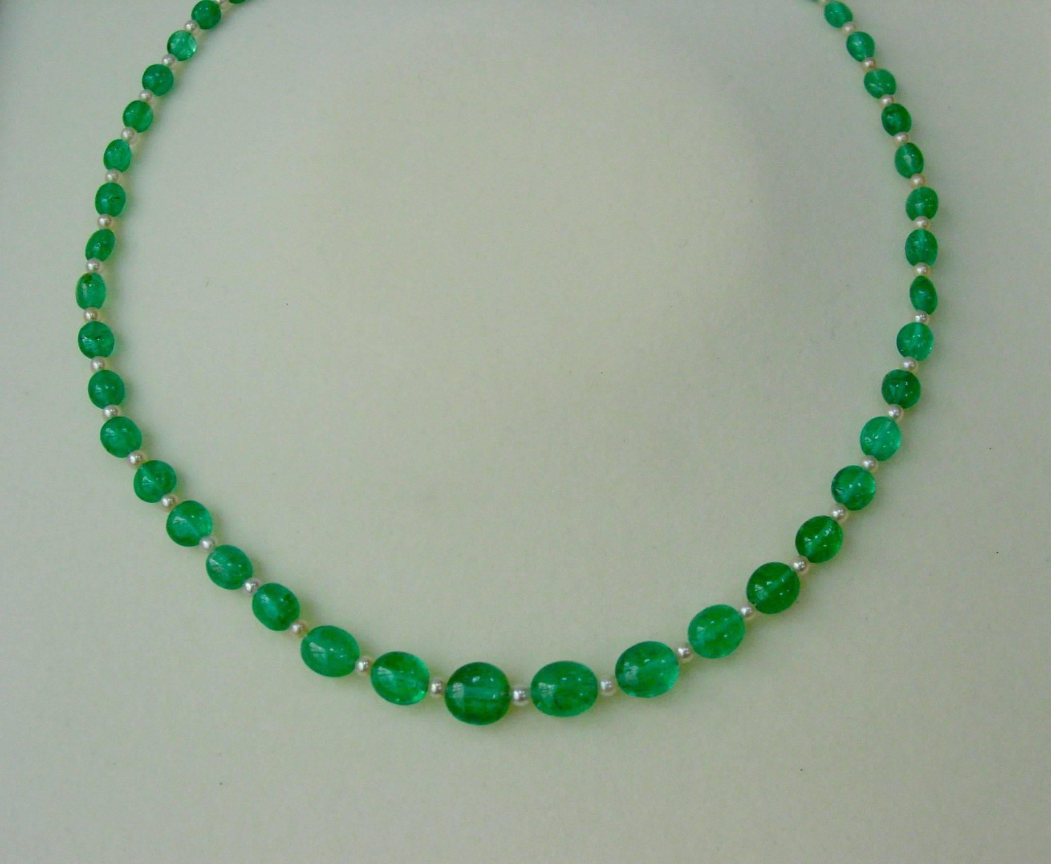 A lovely early twentieth century necklace by the distinguished Philadelphia firm of J.E. Caldwell. The necklace is composed of a graduated strand of translucent emerald beads with alternating pearls and is completed by a platinum and diamond clasp.