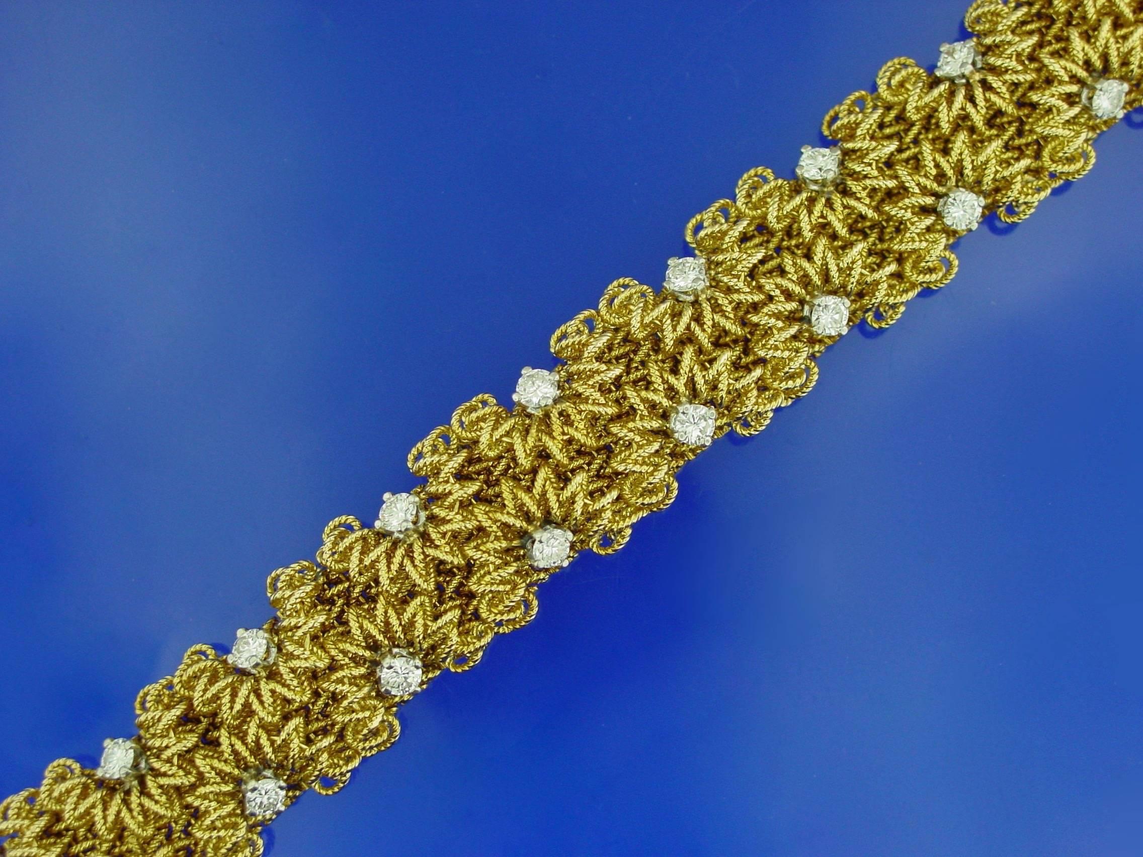 A  superbly crafted French 18 karat yellow gold and diamond bracelet. This very striking bracelet features round brilliant diamonds nestled in a stylized looped wire design. As a testament to the exquisite craftsmanship, this bracelet has no rough