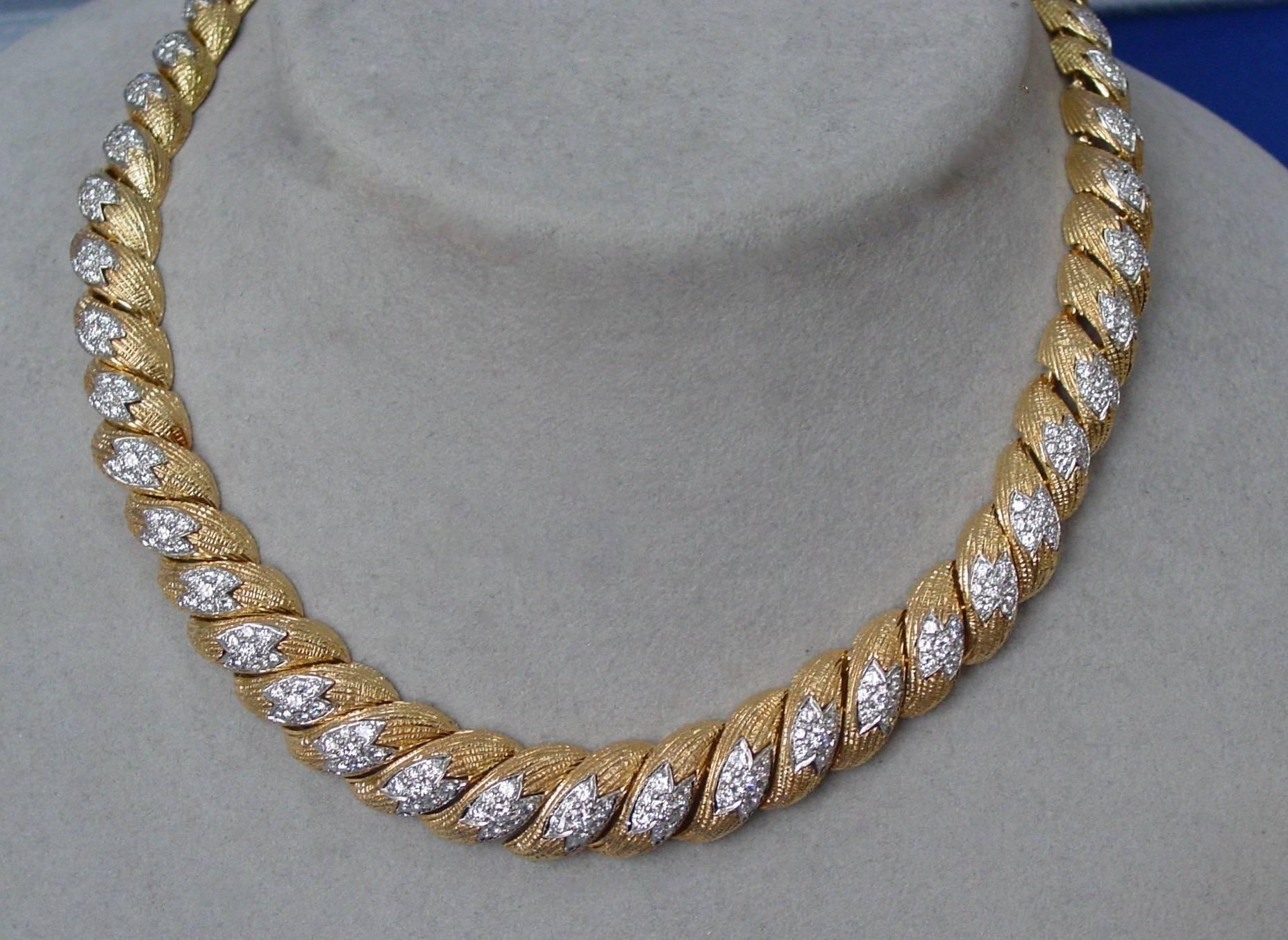 A stylish and very wearable 18 karat yellow and white gold diamond 16 inch necklace. Composed of textured gold links featuring centers of round diamonds mounted in white gold this necklace tapers from 13.75mm to 10.95 mm. Total carat weight is