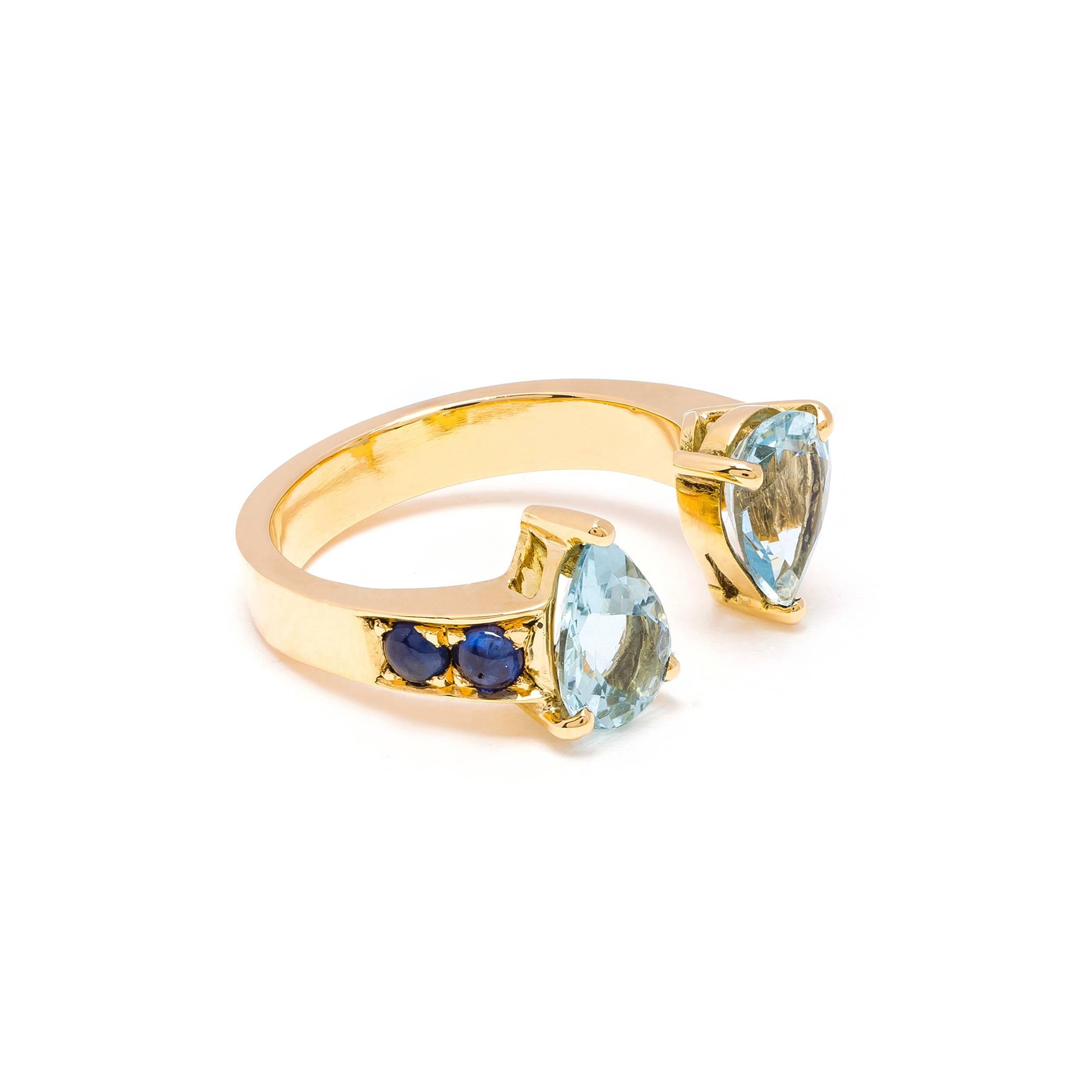This DUBINI ring from the 'Theodora' collection features aquamarine drops with blue sapphire cabochons set in 18K yellow gold. 

Ring sizes available: 52 (US 6)

The ring may be ordered in any size with a lead time of 3-4 weeks.

Please note that we