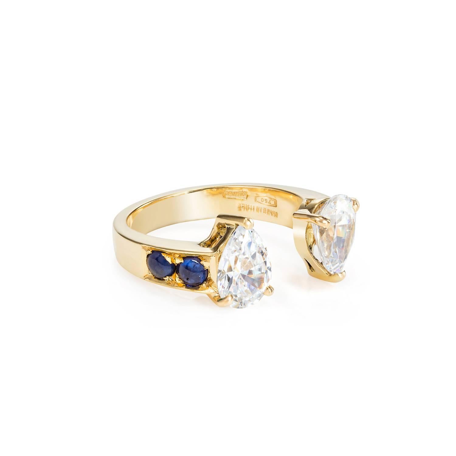 This DUBINI ring from the 'Theodora' collection features white topaz drops with sapphire cabochons set in 18K yellow gold. 

This ring may be ordered in any size with a lead time of 3-4 weeks.

Diamonds can be used instead of White Zircon - PRICE