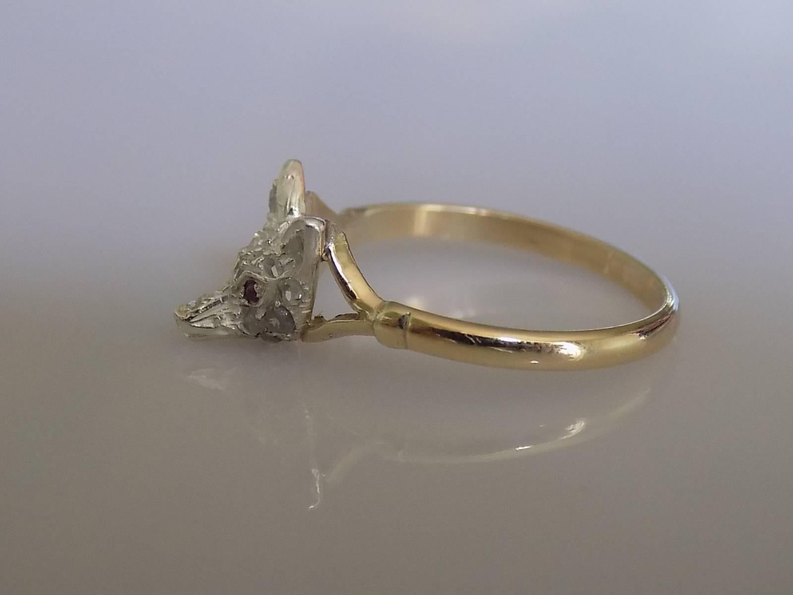 A Lovely Antique Victorian Silver and rose cut Diamond Fox head with a Ruby eyes stick pin conversion ring on Vintage 9 Carat Gold split shoulders shank.  Unique.

Size K 1/2 UK, 5-5.5 US.

Height of the face 8mm. 

Weight 1.7gr.

Full