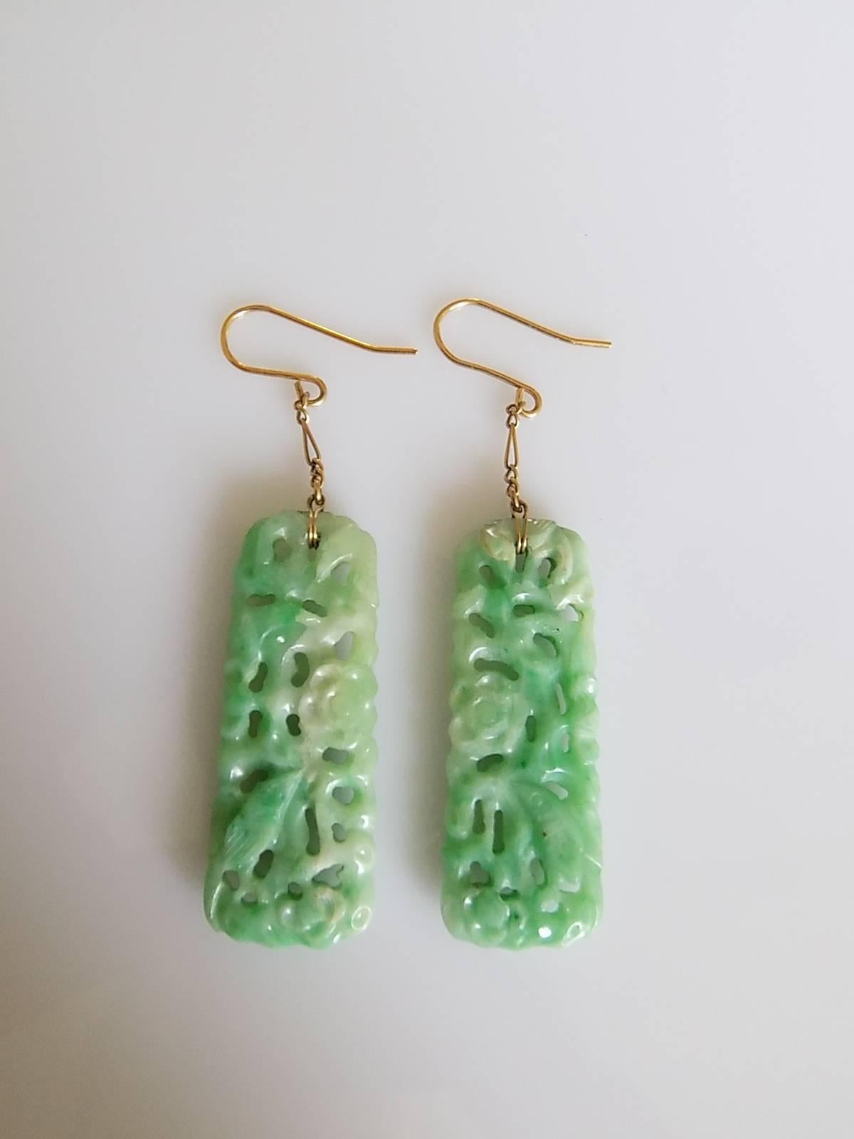 A Spectacular Art Deco c.1920s carved Jadeite Jade pendant earrings on fancy 18 Carat Gold chains (tested) and brand new 9 Carat Gold hooks (marked 375 for 9 carat gold) for pierced ears. Each earrings carved with a flowers, birds and foliage