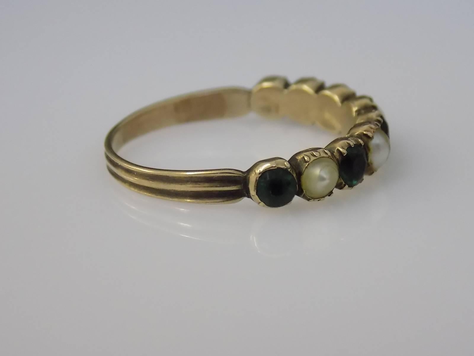 A Lovely Georgian c.1800 15 Carat Gold, Emerald colour paste and natural split Pearl ring. Slight graduated stones in close back setting. Stackable. English origin.
Size S 1/2 UK, 9.75 US.
Height of the face 4.2mm.
Unmarked, tested 15 carat gold.