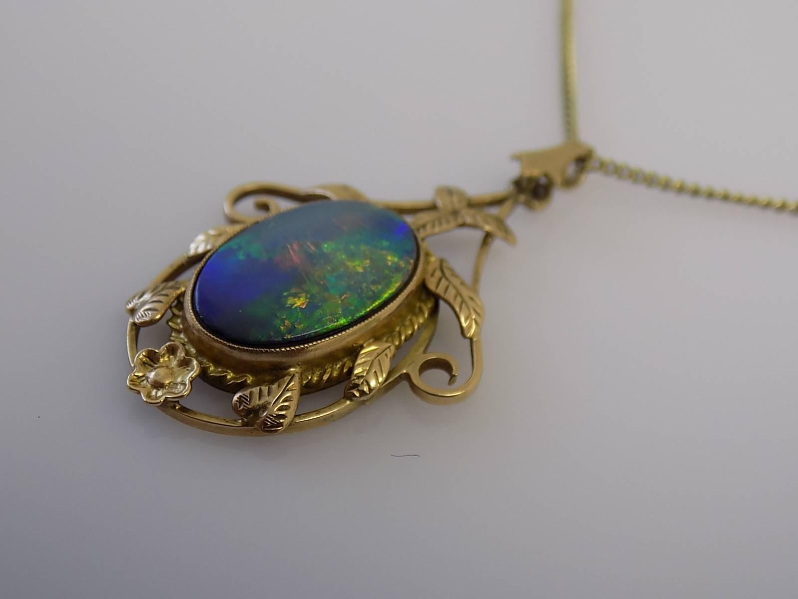 A Gorgeous early 1900s Arts & Crafts period 9 Carat Rose Gold & Doublet Black Opal pendant on a 9 Carat Yellow Gold chain. English origin.
Total drop of the pendant including bale 37mm, Width 21mm.
Opal 19mm x 10mm.
Length of the chain