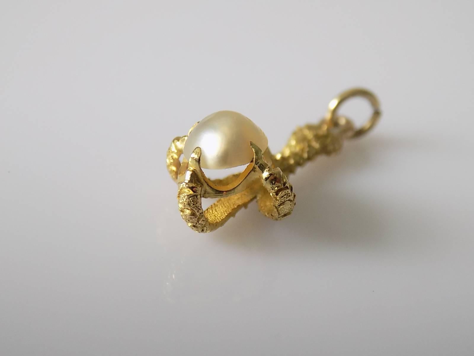 A highly detailed Antique c.1890 French 18 Carat Gold and Natural half Pearl Claw pendant / charm.
Total drop including jump rings 25mm (1