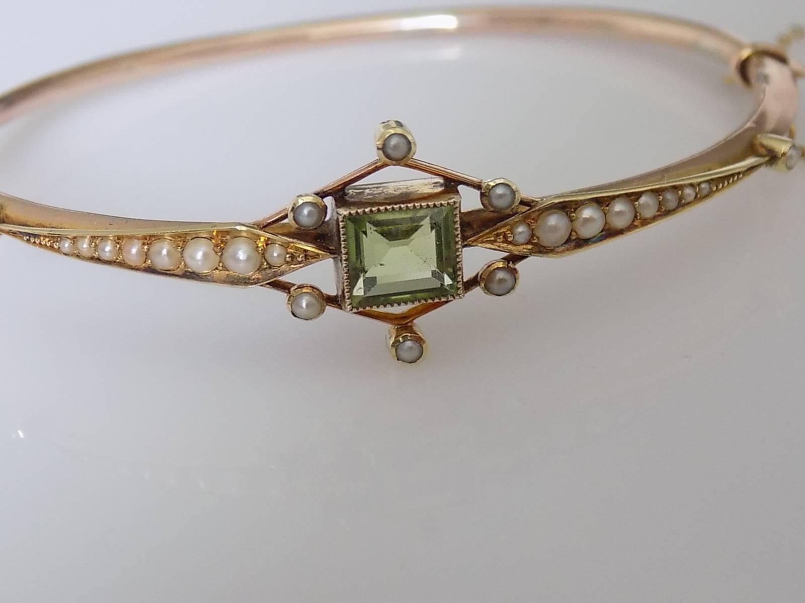 A Gorgeous Edwardian c.1907 9 Carat Gold, Peridot and split seed Pearl Bangle. Bangle complete with working "push in" clasp and safety chain. English origin.
Height of the face 17mm.
Diameter inside of the bangle 60mm x 50mm.
Full Chester