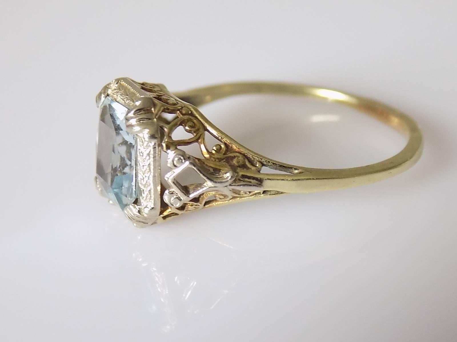 A Gorgeous Art Deco c.1920s/30s 14 Carat Gold filigree style solitaire ring with an Aqua colour crystal in white and yellow Gold setting. American origin. 
Size S UK, 9.5 US. 
Height of the face 11mm. 
Weight 2.5gr. 
Marked 14K for 14 Carat Gold. 
