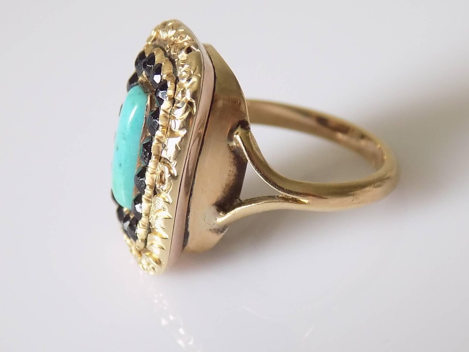 A Georgian 9 Carat Gold, Turquoise and French Jet mourning ring. Ring signed at the back and dated January 1823. Ring complete with a slight late, well made shank. 
English origin.

Size L 1/2 UK, 6.25 US - sizable. Height of the face 21mm, width