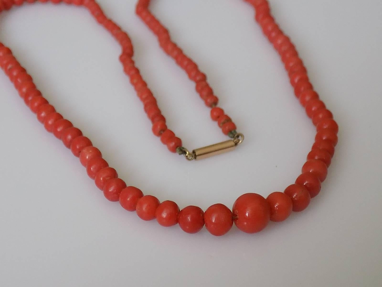 An Antique Victorian c.1880s natural Red Salmon Coral beads necklace on gold "Push In" barrel clasp. English origin.
Length of the necklace including clasp 19". 
The beads graduated from 2mm to 6mm.
Weight 13.1gr.
The necklace in