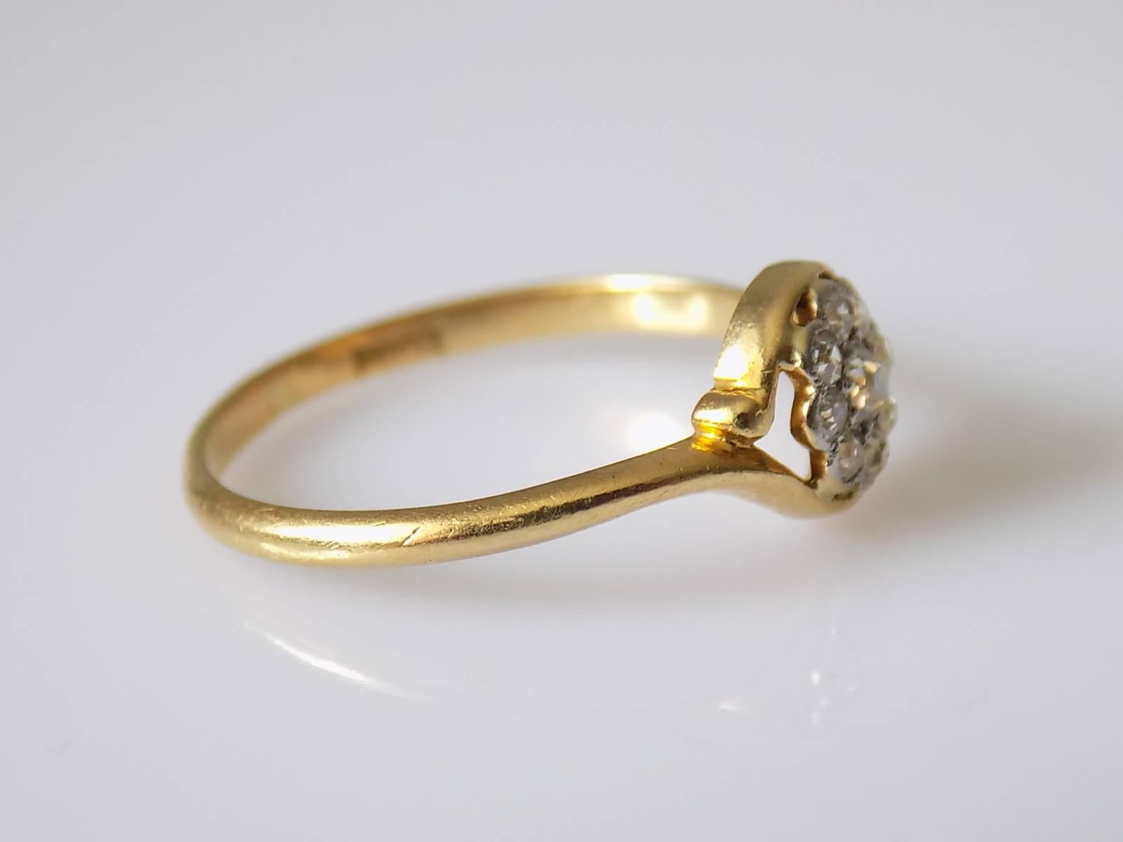 A Lovely Antique Edwardian c.1910 18 Carat Gold and 0.23 Carat Old European cut Diamond Daisy cluster engagement ring. English origin.
Size O UK, 7.5 US.
Height of the face 8mm.
Total weight of the Diamonds approx. 0.23 Carat.
Weight 2.0gr.
Marked