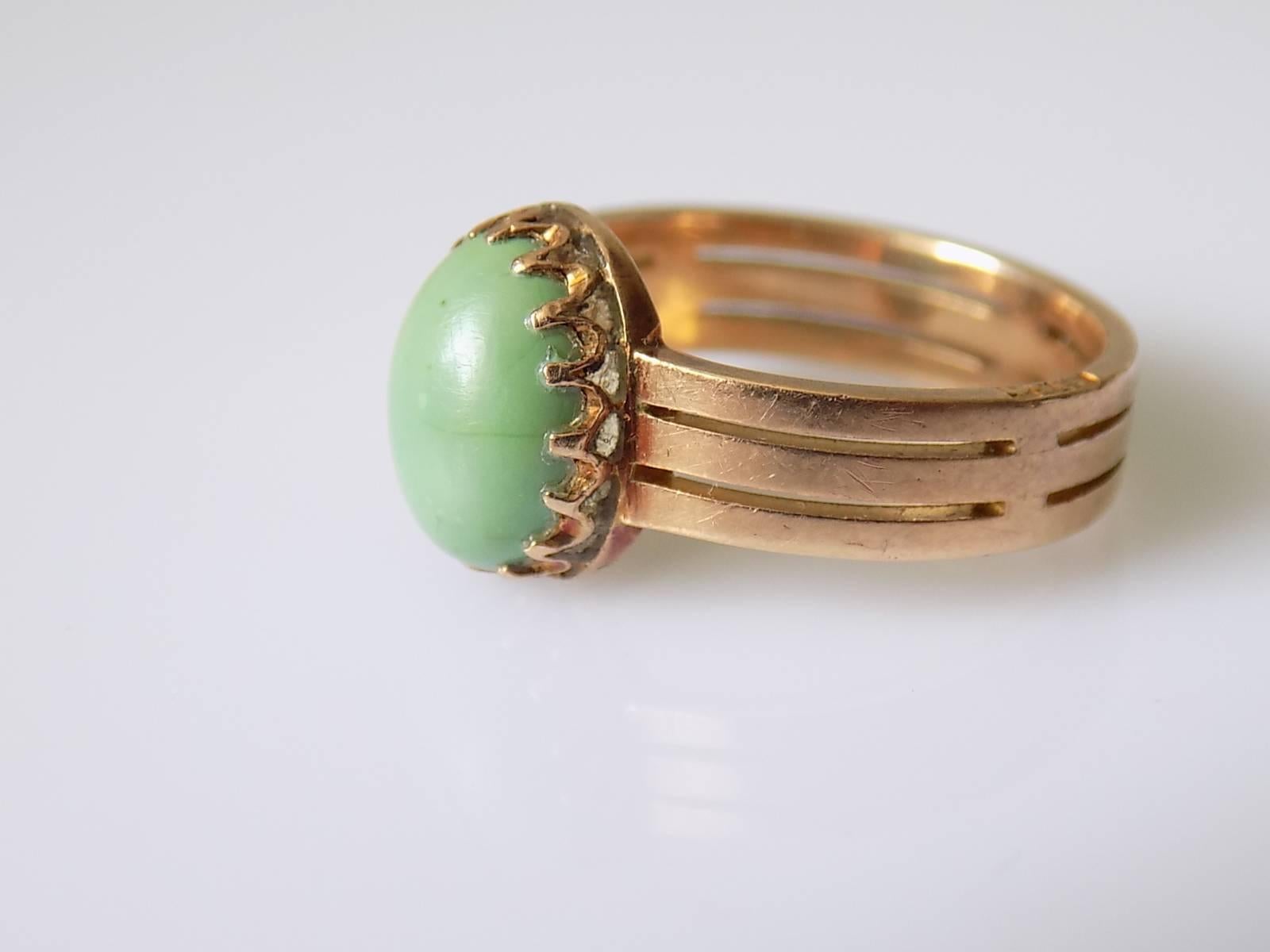 A Victorian c.1890 15 Carat Rose Gold and Green colour Turquoise cabochon solitaire ring. Turquoise mounted in a beautiful crown style setting on a thick tripple effect shank.
Size N UK, 6.5 US.
Height of the face 11mm. 
Weight 4.7gr.
Marked 15 with