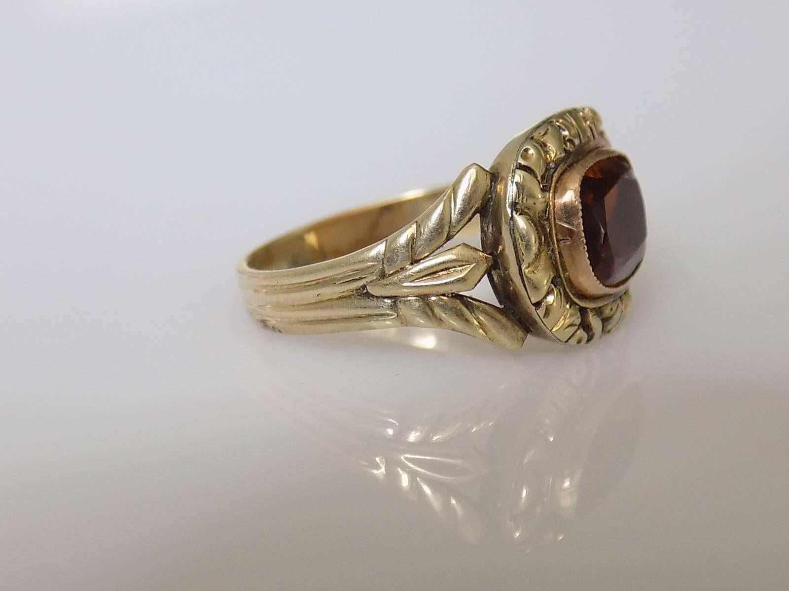 An Antique Georgian c.1800 Hessonite Garnet Paste solitaire ring. The Paste in a beautiful, chased gold setting on ridged shank.
Size N UK, 7 US
Height of the face 12mm, width 15mm.
Weight 4.2gr.
Unmarked, tested 9 Carat Gold.
Ring in excellent