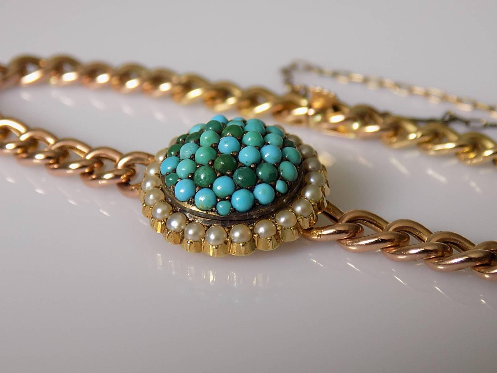 An Unique Antique Victorian 15 Carat Gold bracelet with a Turquoise and Pearl Target detail to the front. Turquoise in Pave setting surrounded by split Seed Pearls. English origin.
Length including clasp 7 1/2