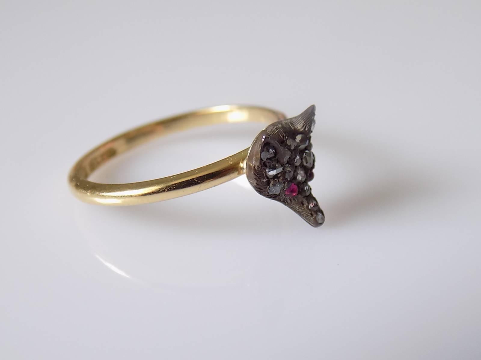 A Cute Victorian Silver, Rose cut Diamonds and Ruby Fox head stick pin conversion ring on 18 Carat Gold shank. 

Size M 1/2 UK, 6.75 US.

Height of the face 9mm, Width 7mm.

Weight 2.5gr.

Shank fully hallmarked for 18 Carat Gold.