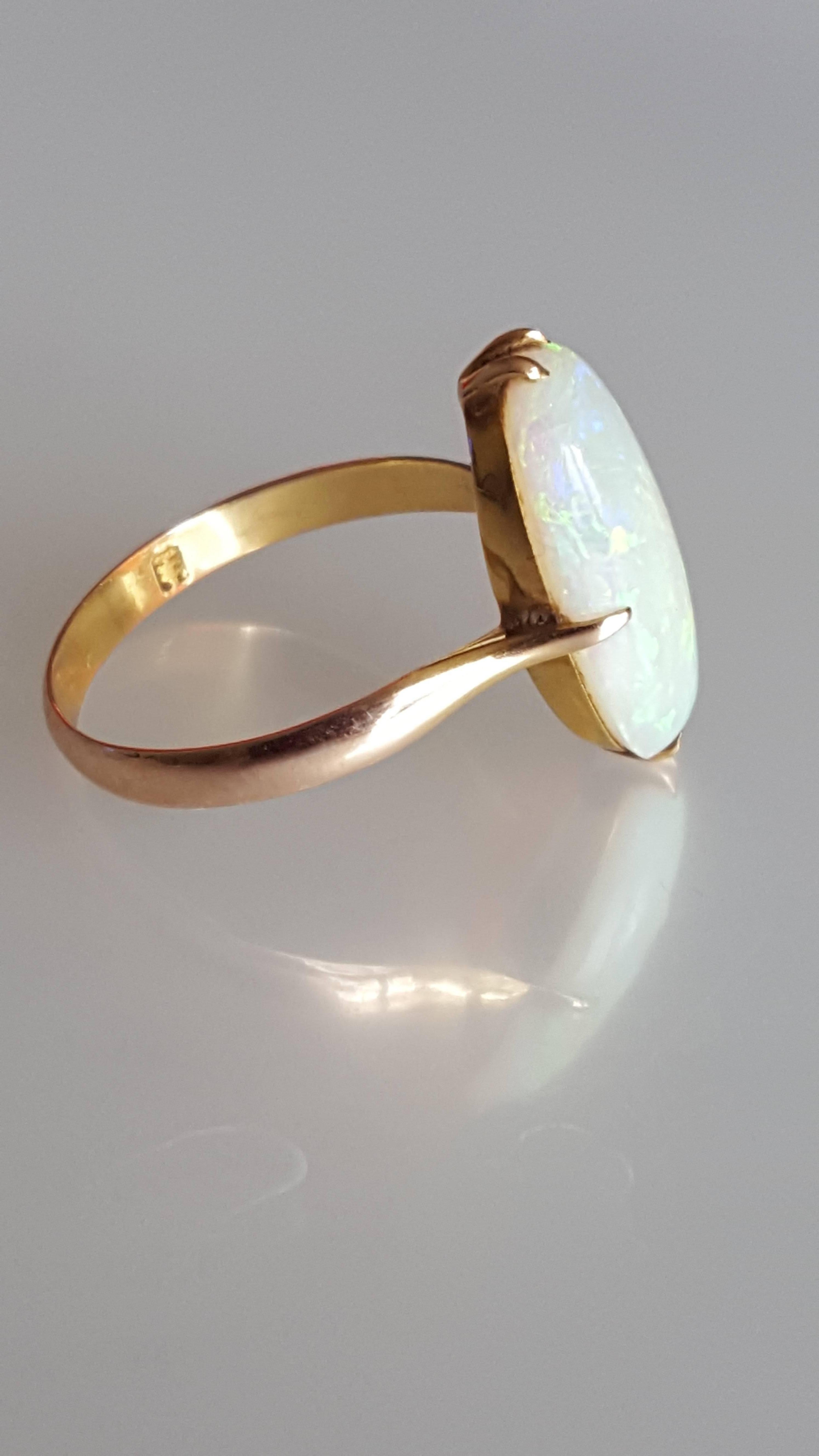 A Beautiful Art Deco c.1920s/30s  18 Carat Gold and Australian Opal ring. October birthstone. 
Size 6.5 US, M UK. 
Height of the face 17mm 
Marked for 18 Carat Gold 
Excellent condition for the age and ready to wear. 