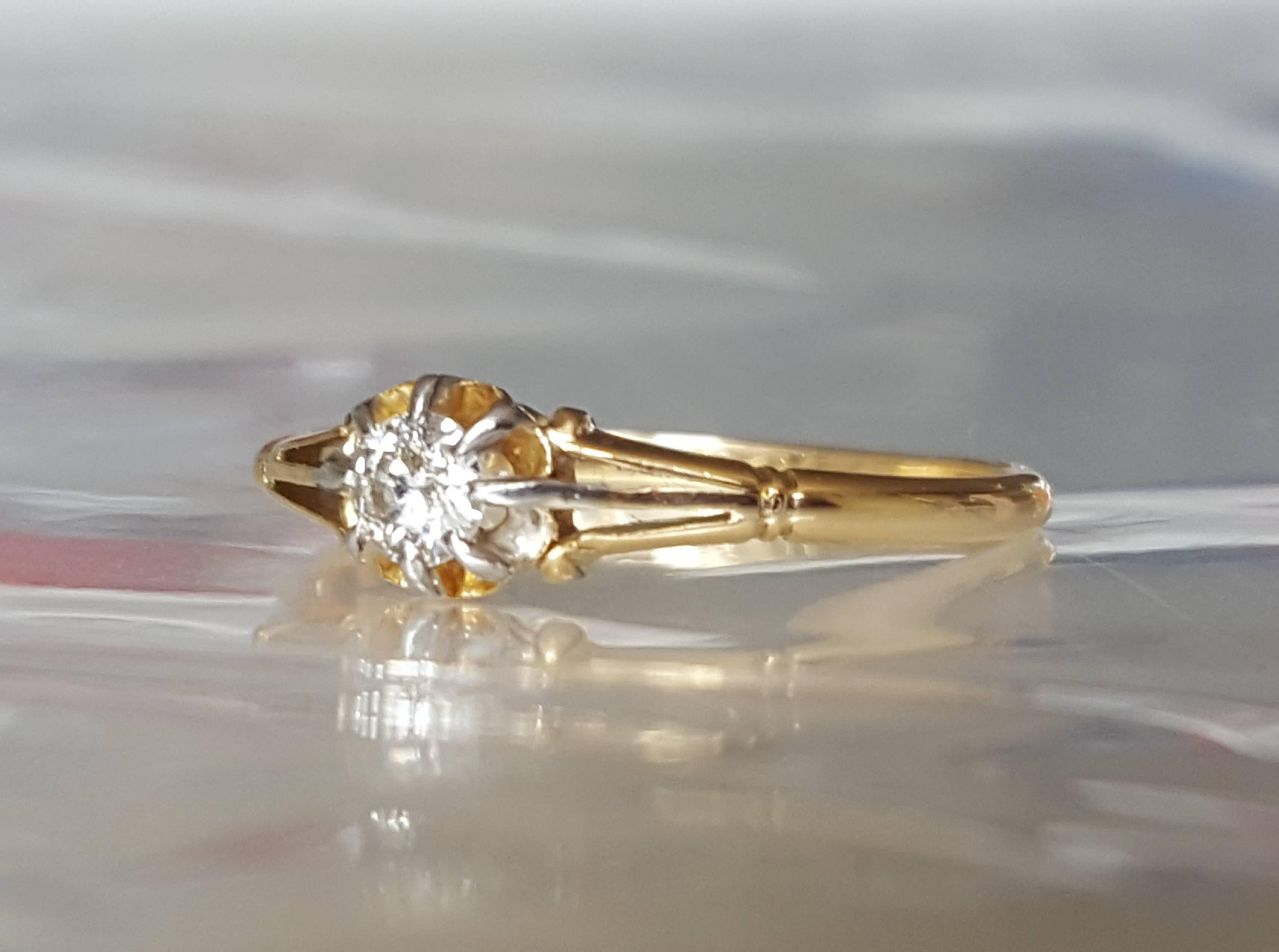 A Lovely Edwardian c. 1913 18 Carat Gold and 0.20 carat Diamond solitaire engagement ring. Diamond in Platinum claw setting. English origin. 
Size 7.5 US, O UK. 
Total height of the face 5mm.
Chester hallmark dated 1913, tested 18 Carat Gold. 